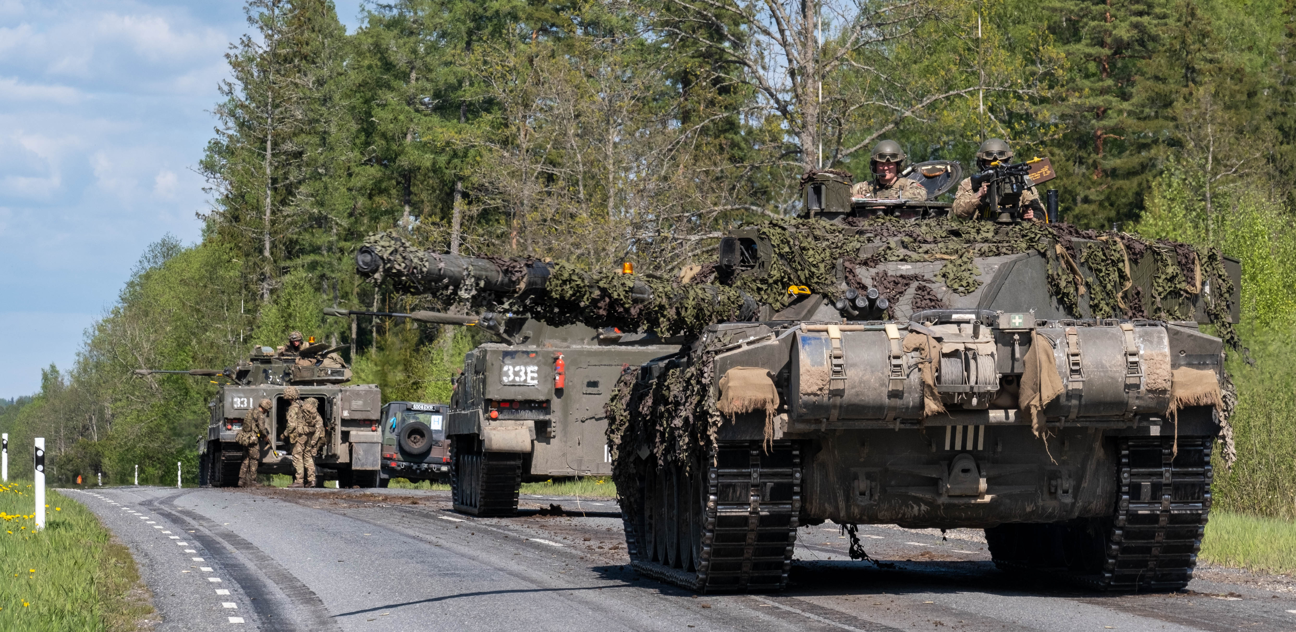 Tanks run down road.