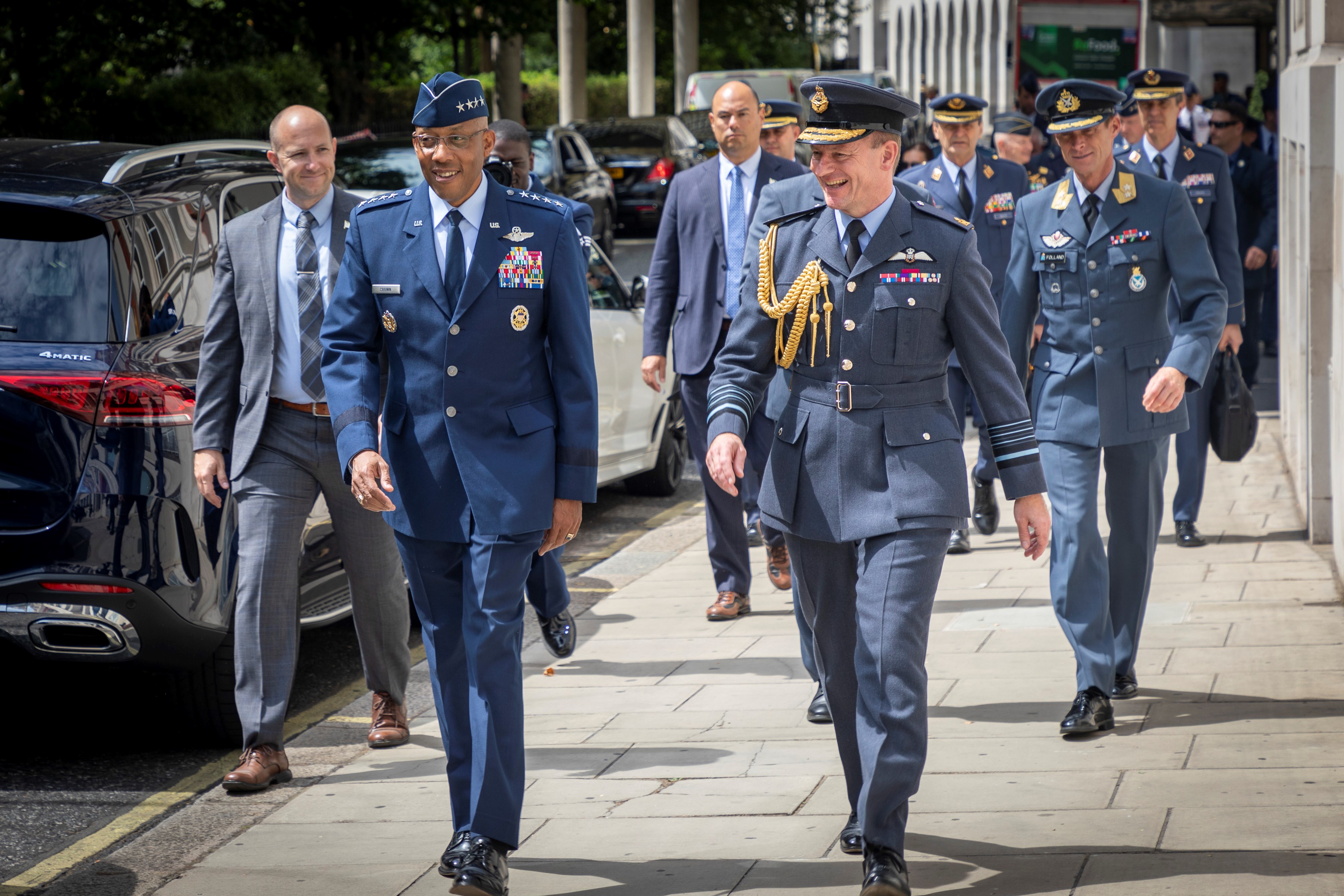 Image shows the Chief of the Air Staff walking in the streets with other aviators.