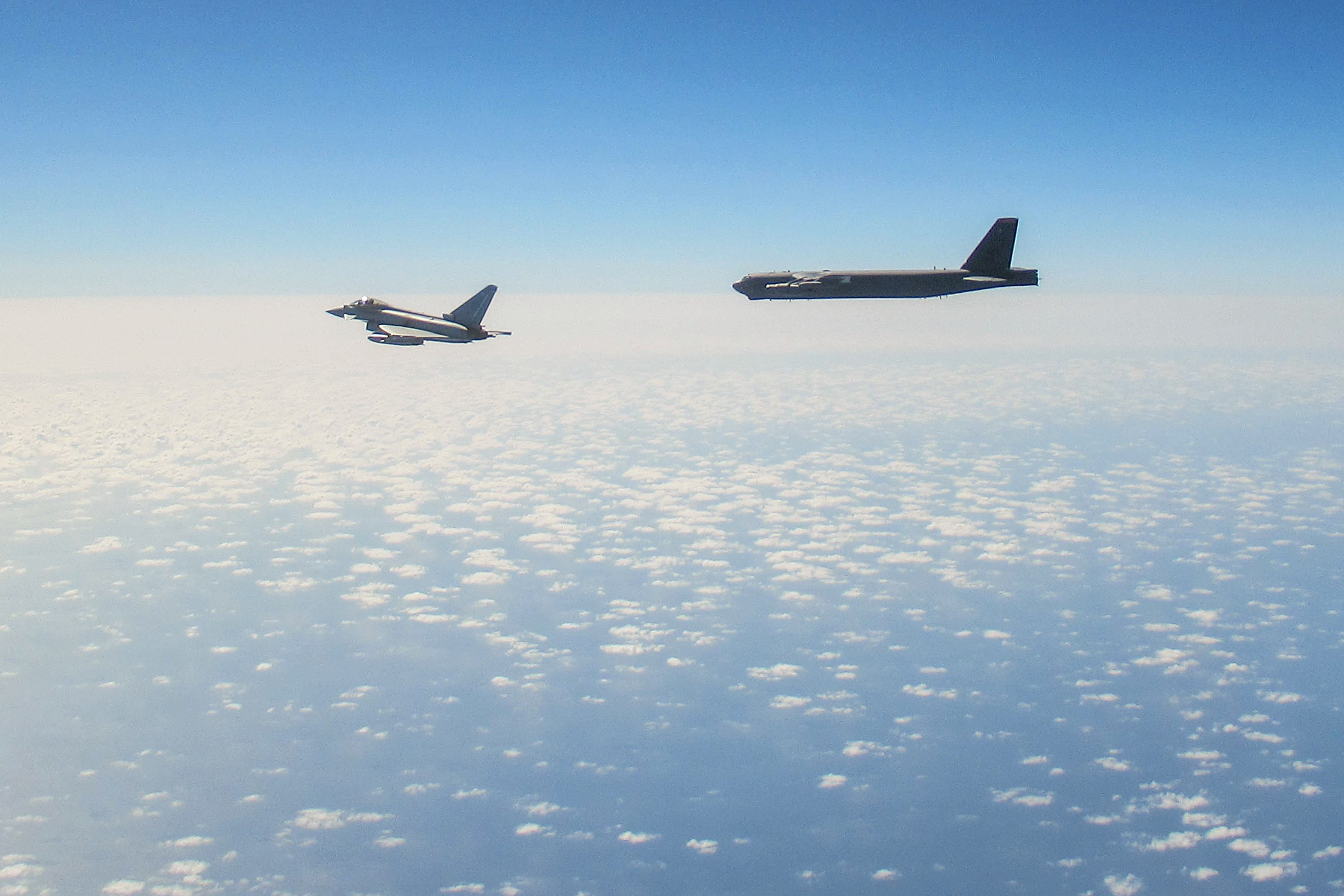 Image shows a RAF Typhoon and B-52 Stratofortresses.