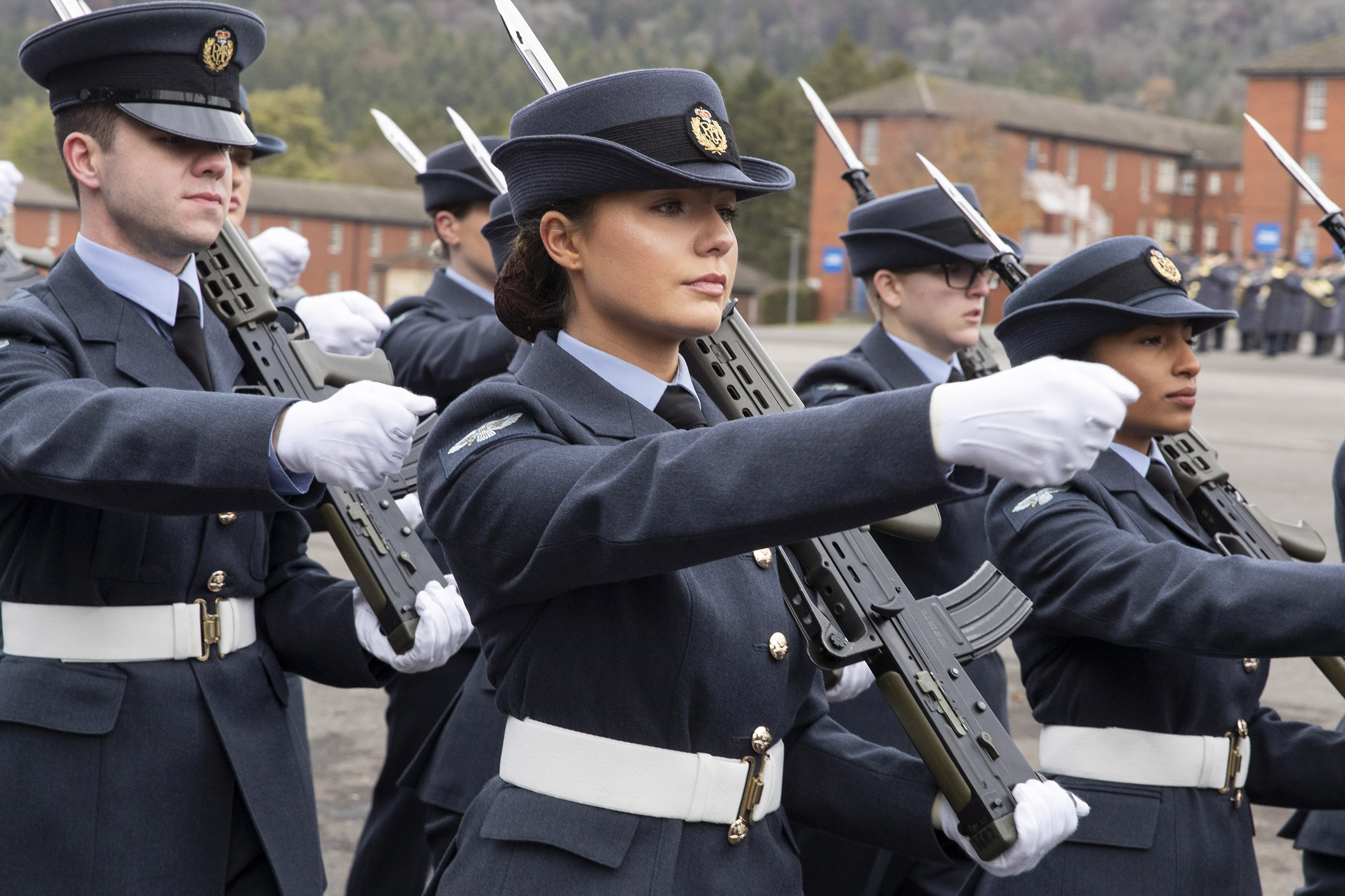 Image shows RAF graduates with rifles during parade.