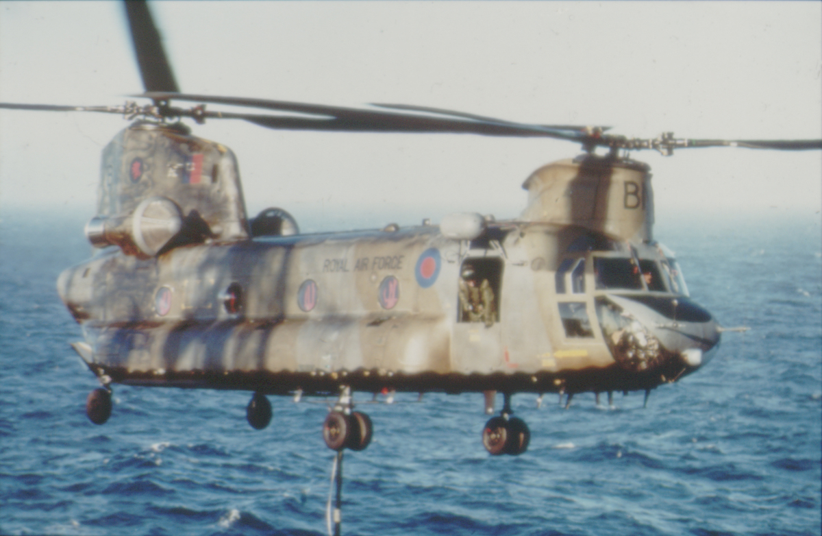 Aged image of helicopter carries sling load.