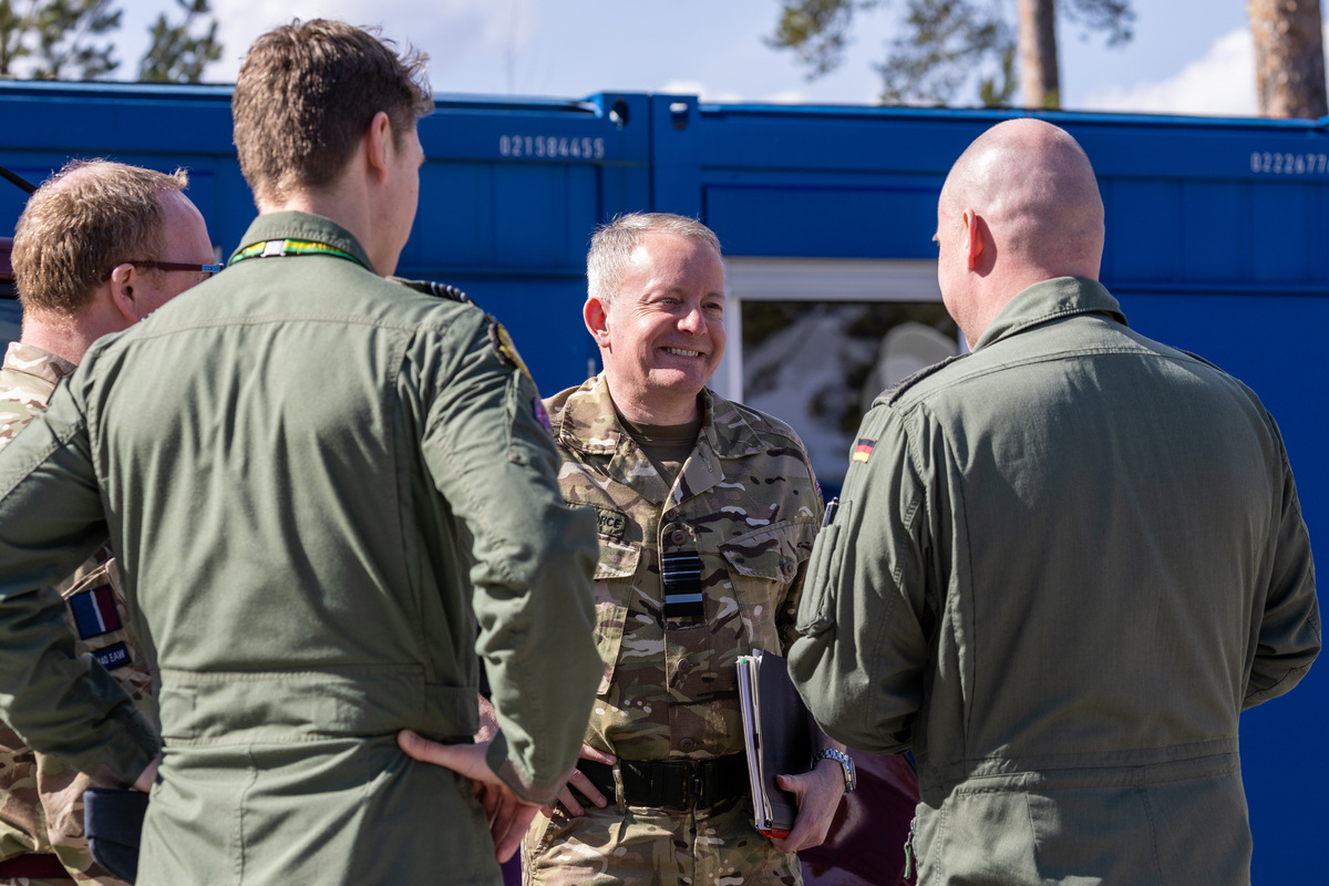 Image shows RAF personnel in discussion.