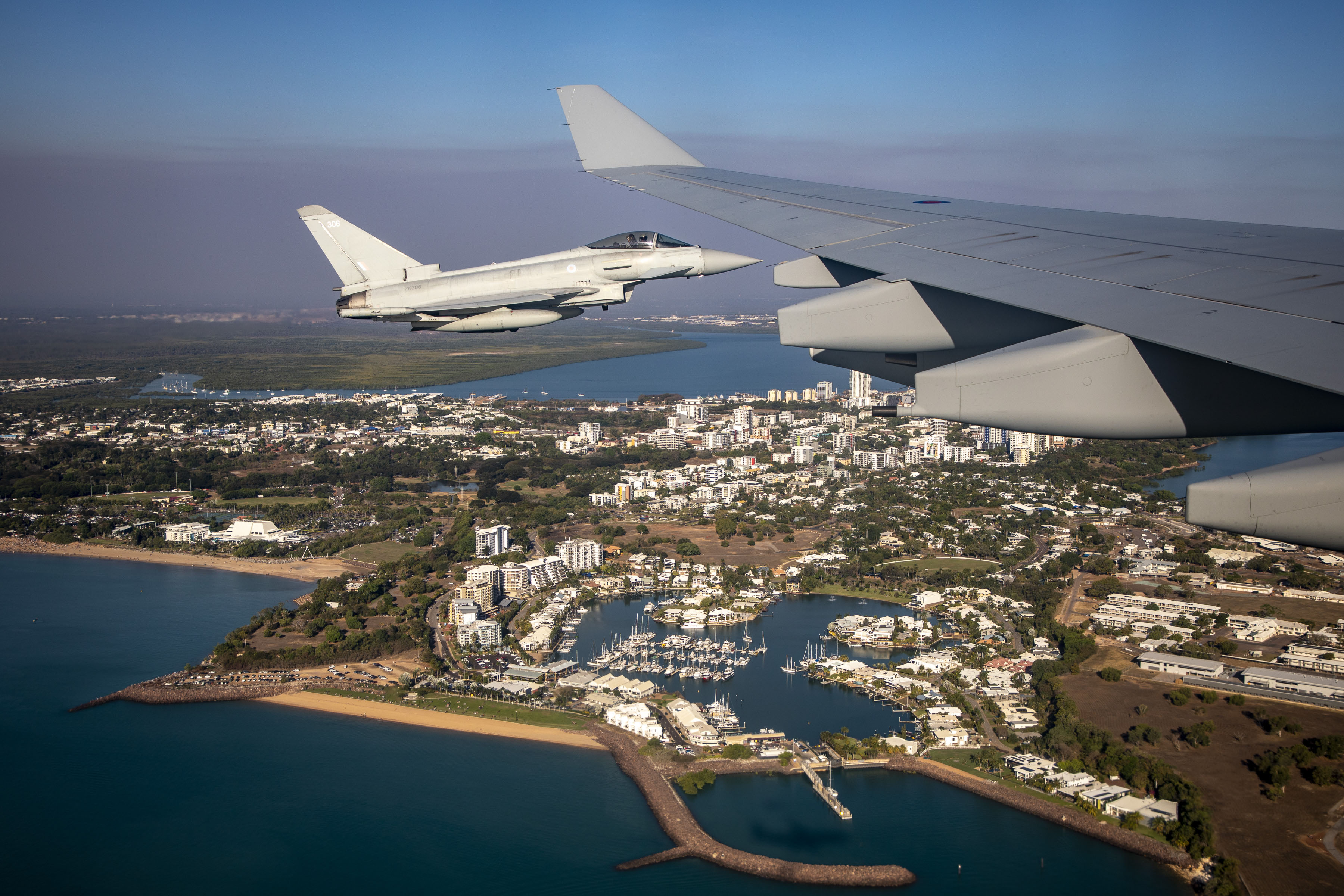 Image shows a RAF Typhoon and the wing of another Typhoon in flight.