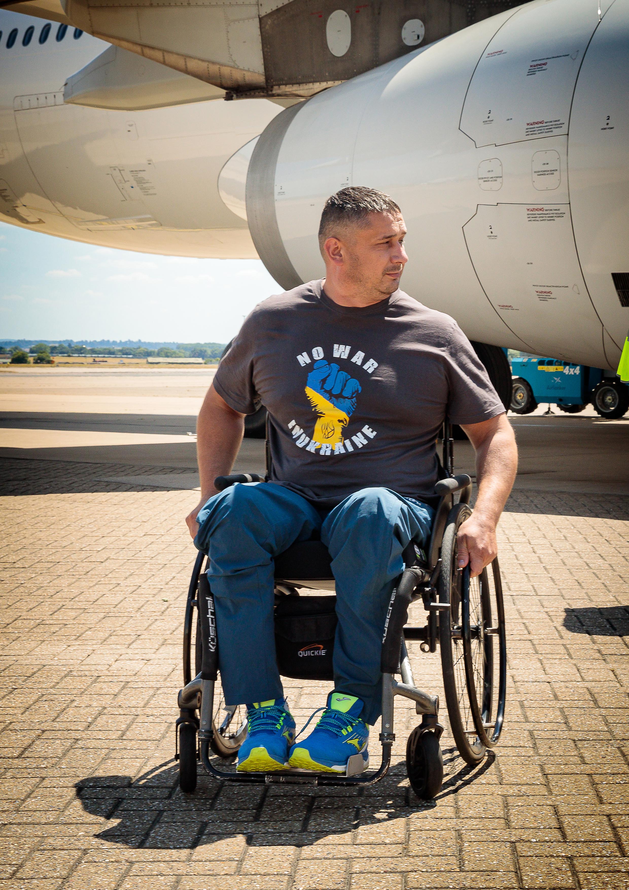 Image shows wheelchair user in front of an RAF Voyager on the airfield.