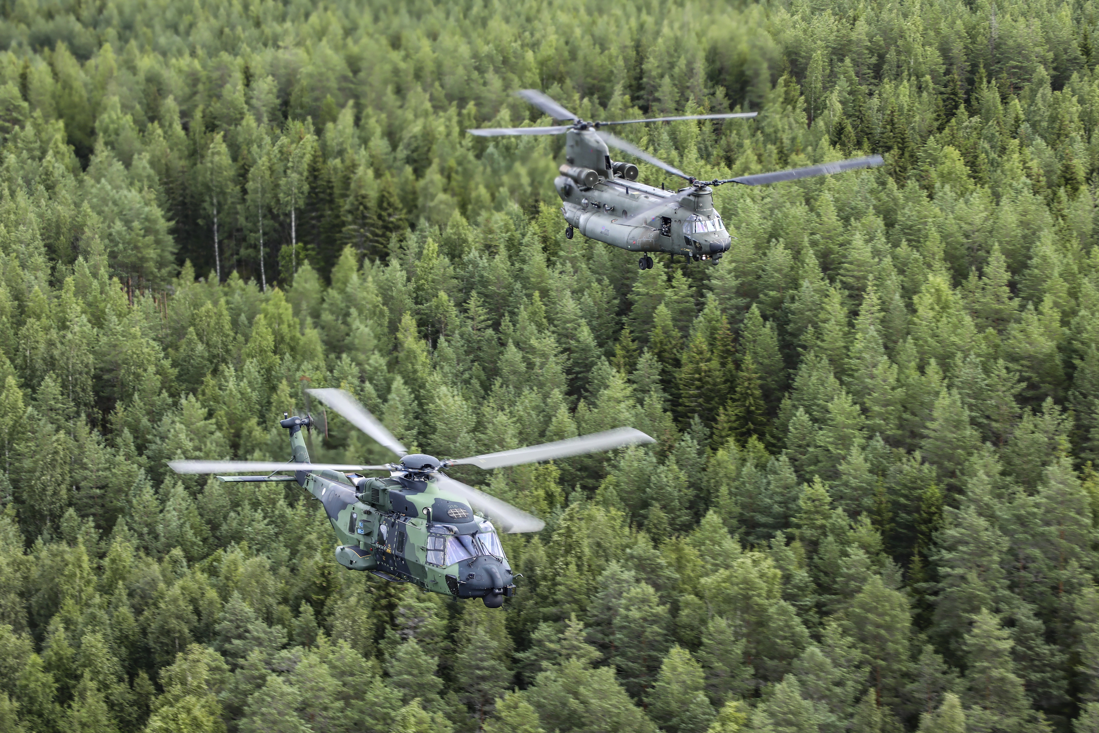 Image shows RAF Chinooks in flight, with camouflage paintwork.
