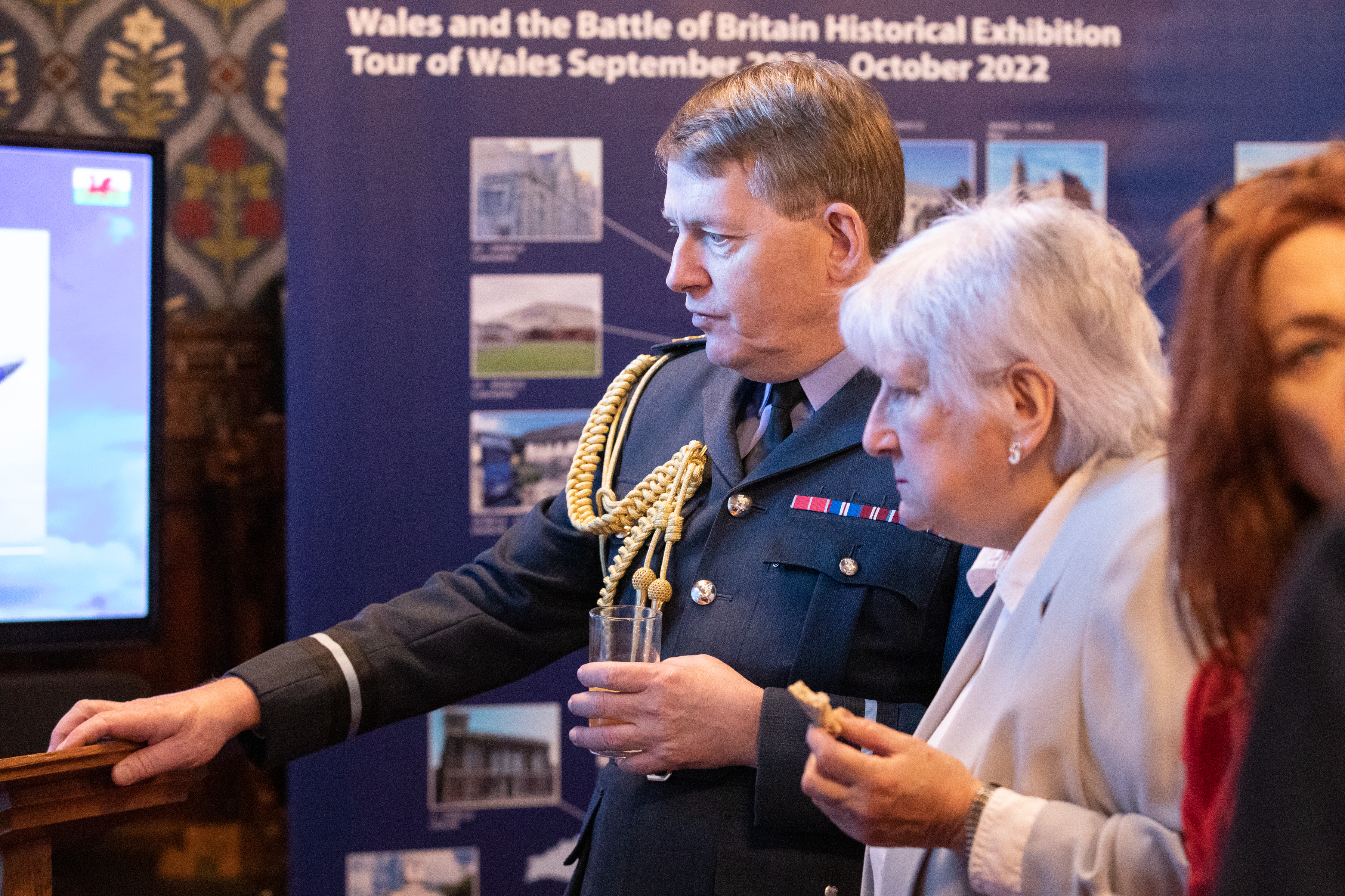 Image shows RAF aviator and civilian at exhibition.