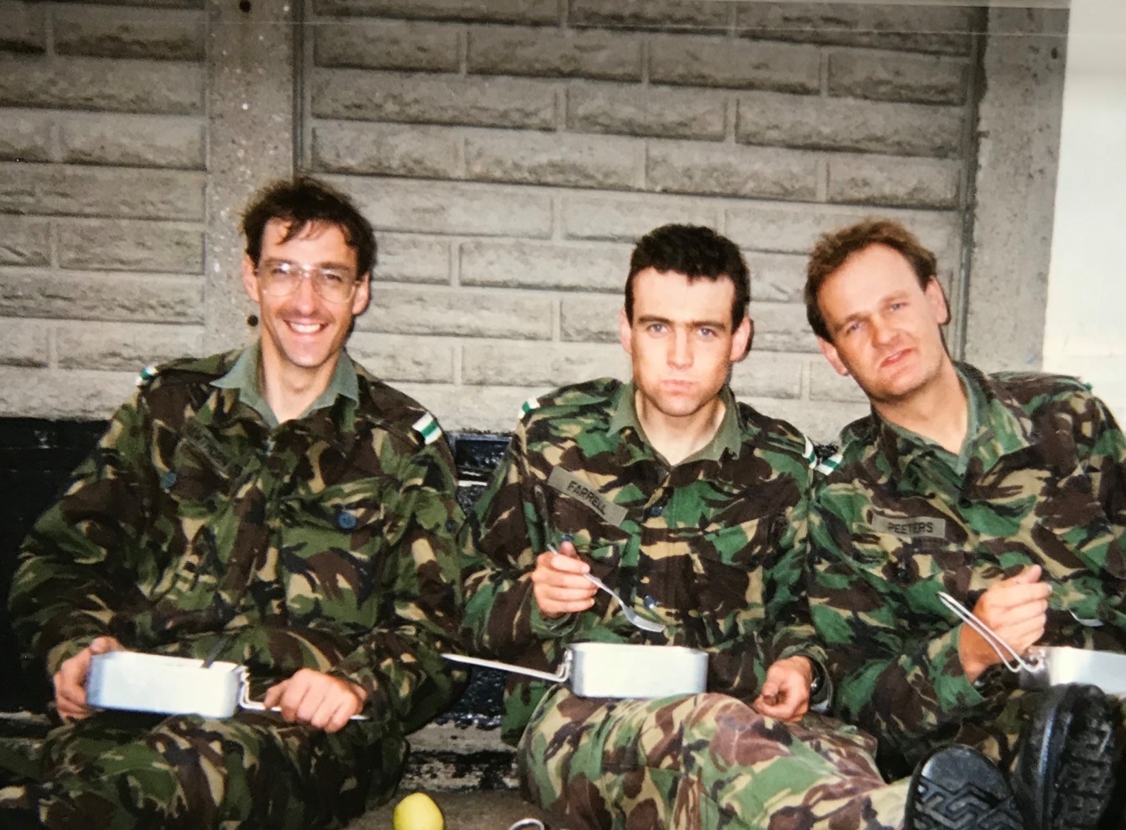 Archived image shows RAF Aviators sitting on the ground eating from their metal food tins.