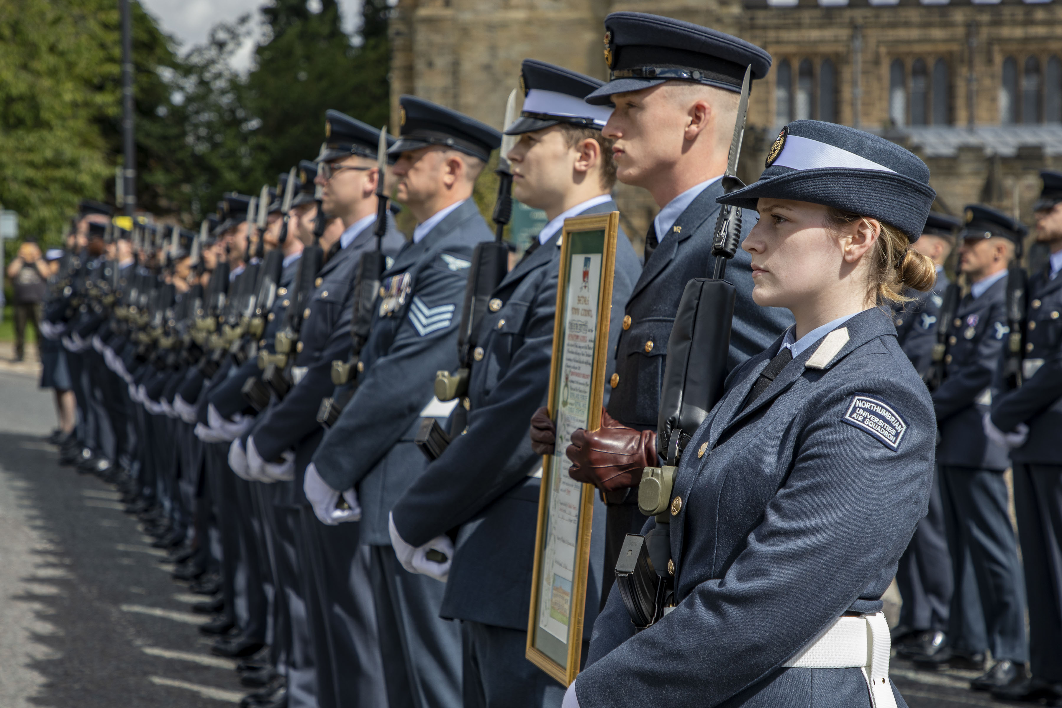 Image shows RAF aviators in parade with Firmin sword certificate.