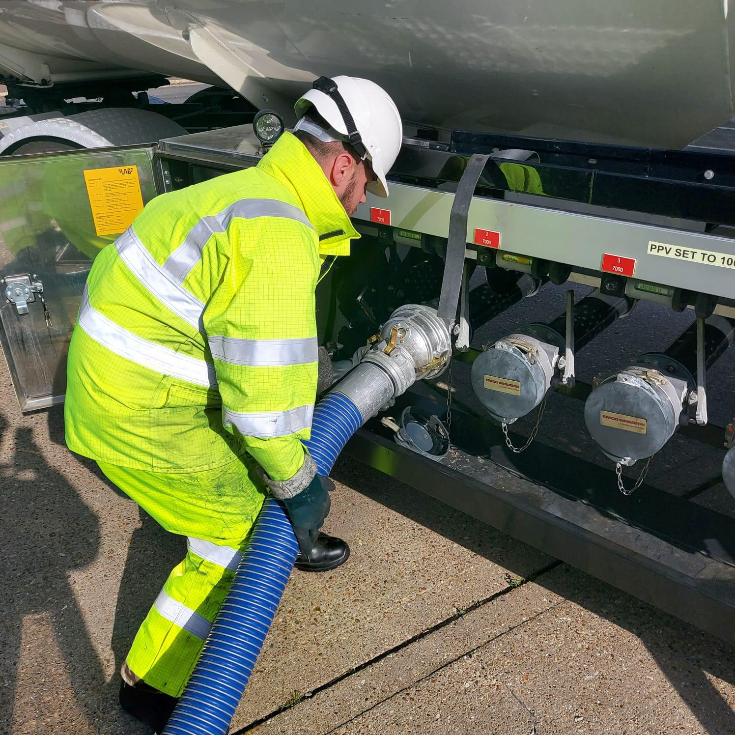 RAF Logistics Driver refuels Lorry with petrol pump..