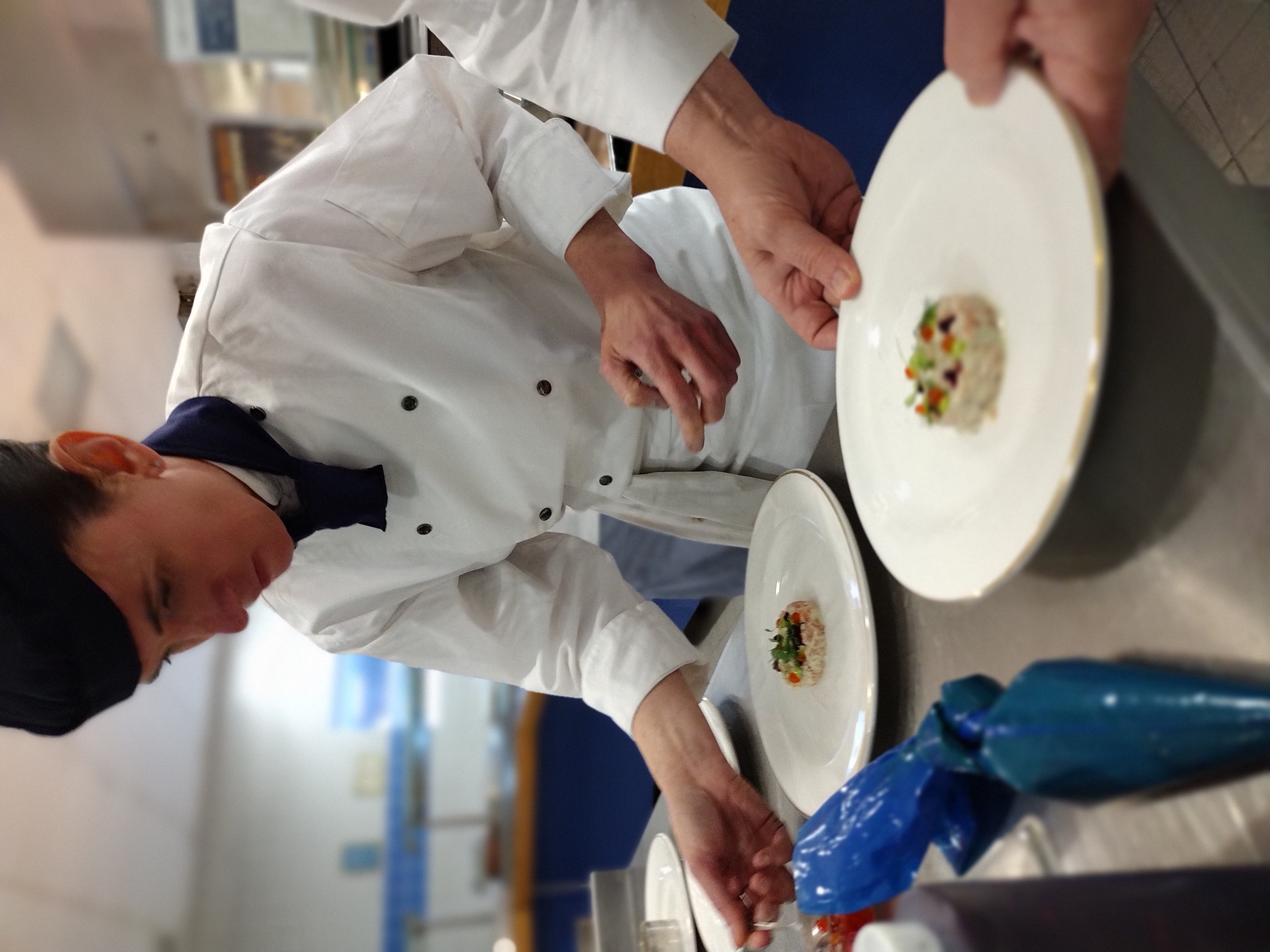 RAF Chef works with plates of food.