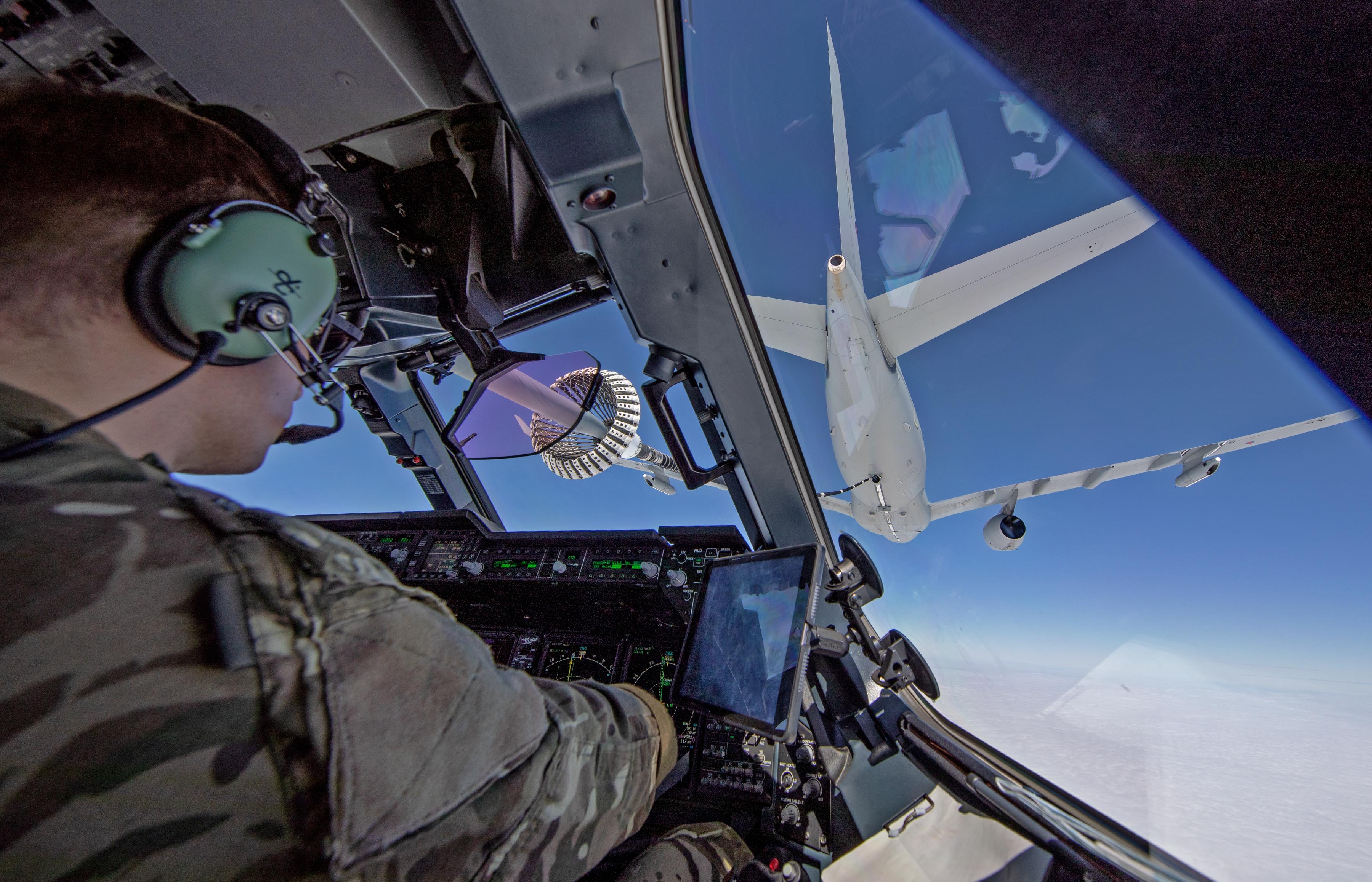 Image shows RAF pilot in the cockpit, while refuelling the carrier aircraft he is following.
