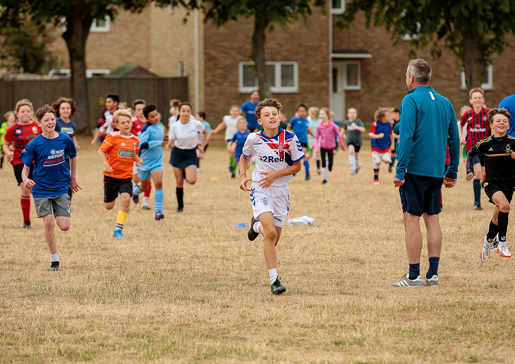 Football Academy Warm-Up Running - Children and young people of personnel at RAF Brize Norton benefitted from a huge range of events organised by Community Support, Airplay and RAFA Kidz this summer.