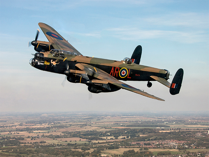 Image shows the Battle of Britain Memorial Flight Lancaster Bomber aircraft in flight.