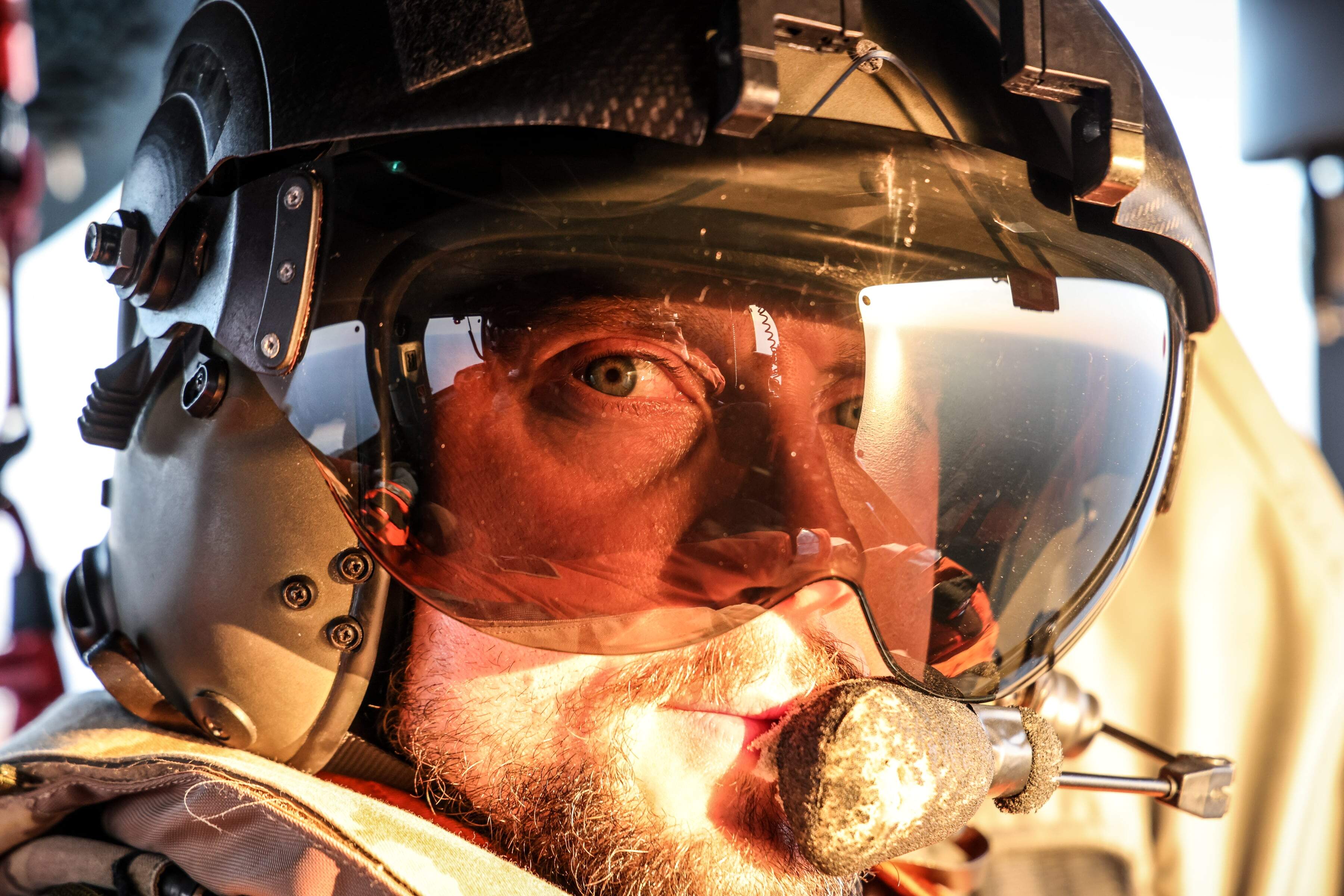 Close up image on a pilot in his helmet looking backwards
