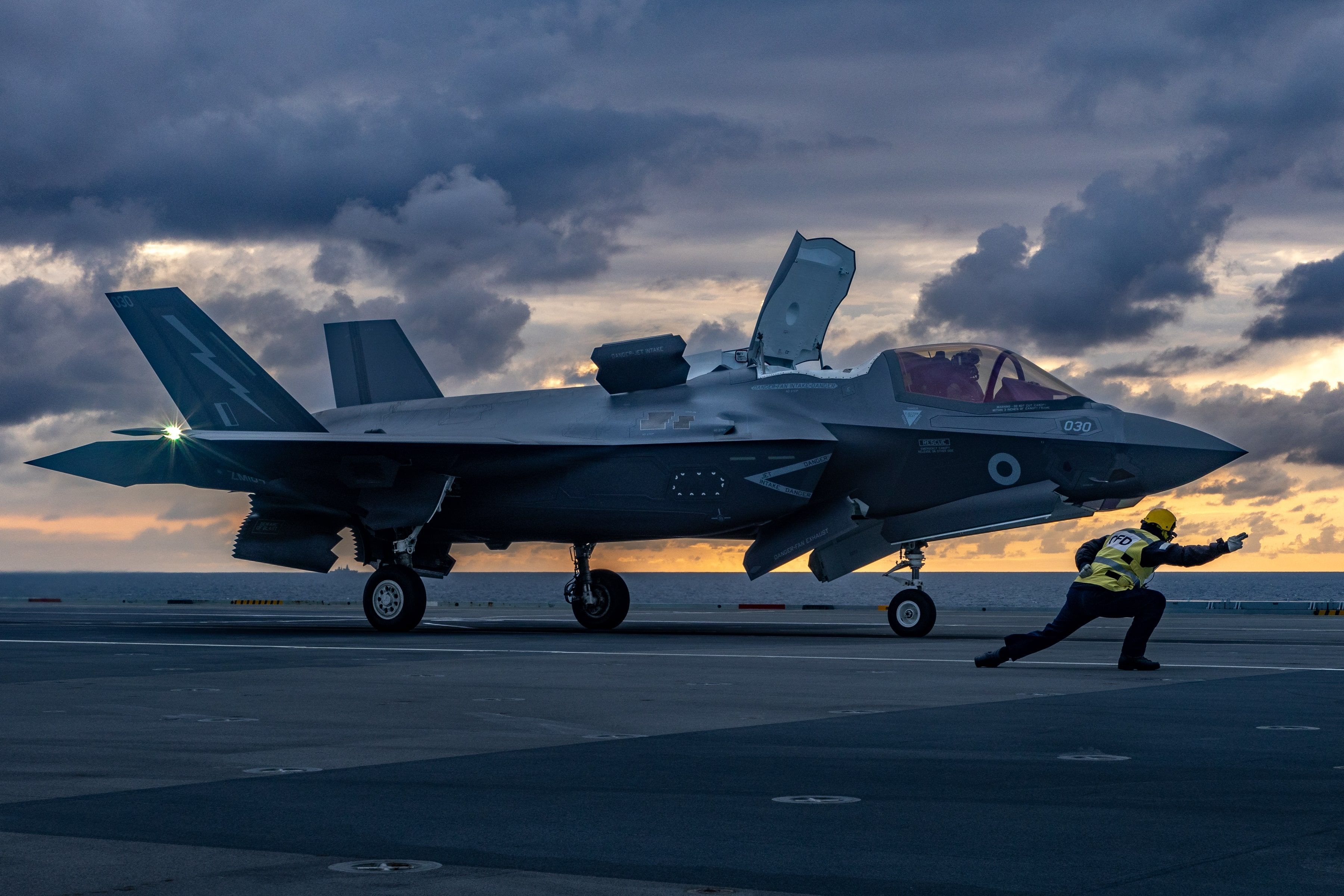F-35B ready to take off on aircraft carrier at dusk