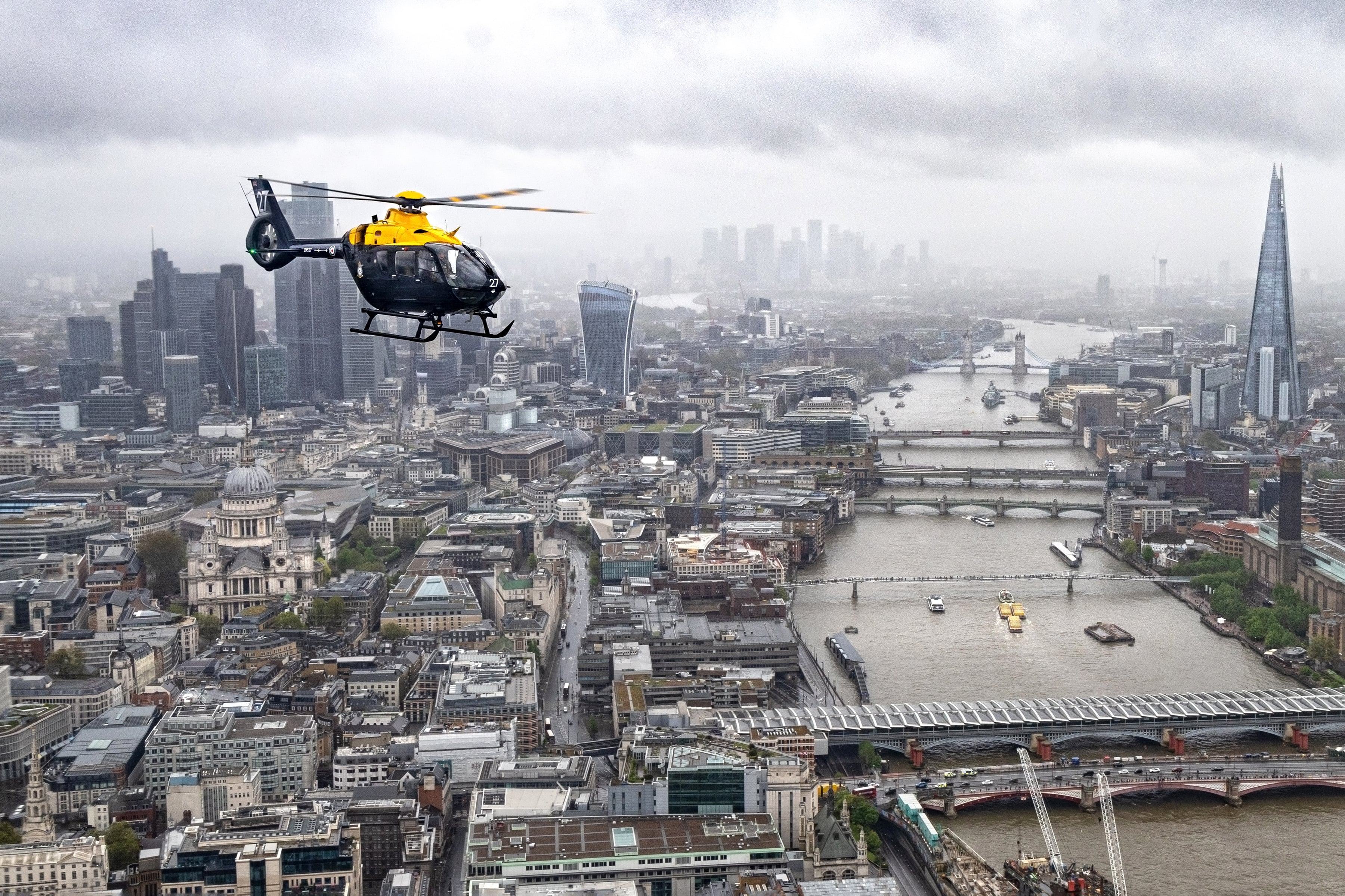 RAF Juno helicopter flying over iconic London landscape
