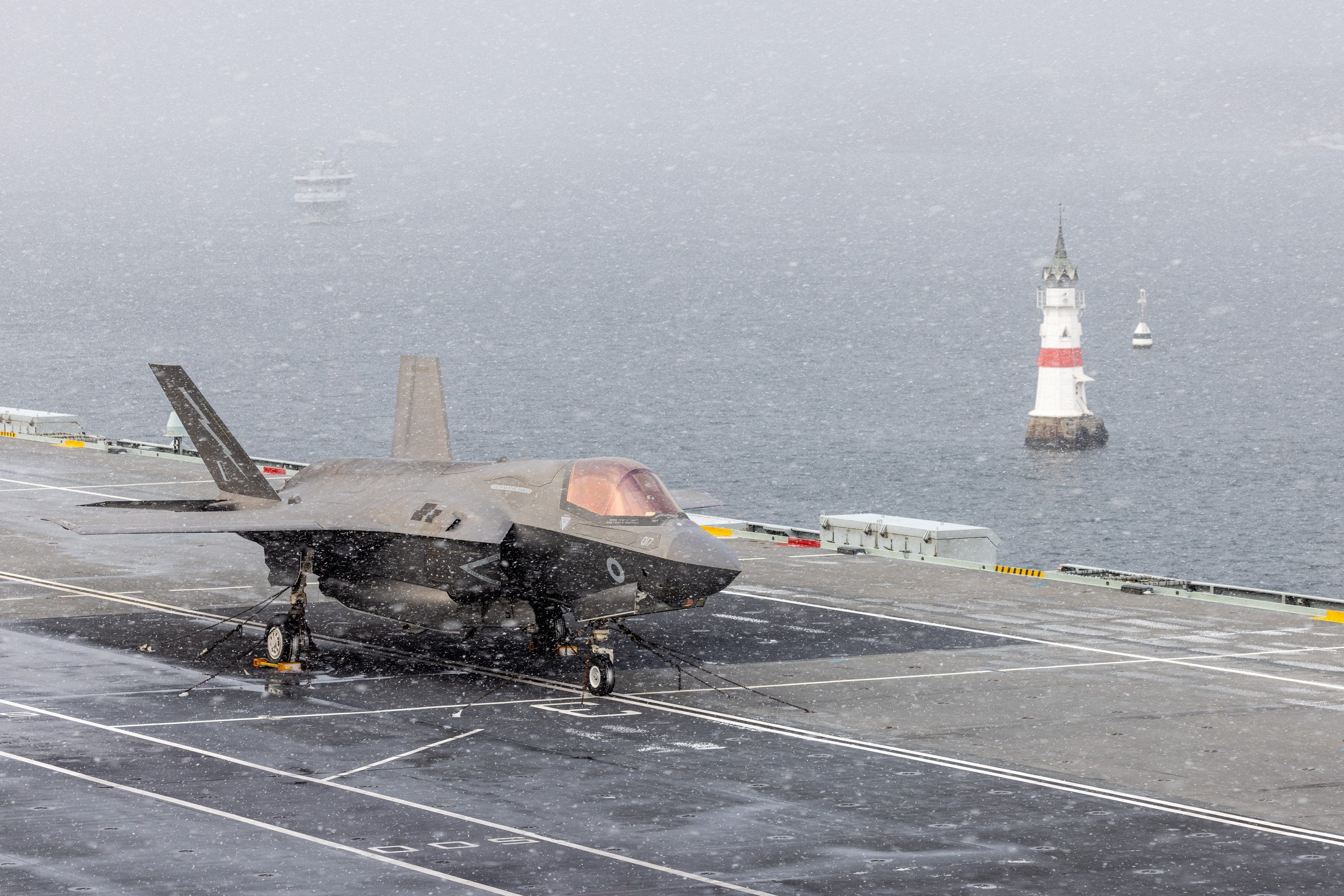 F-35B anchored on aircraft carrier in snow