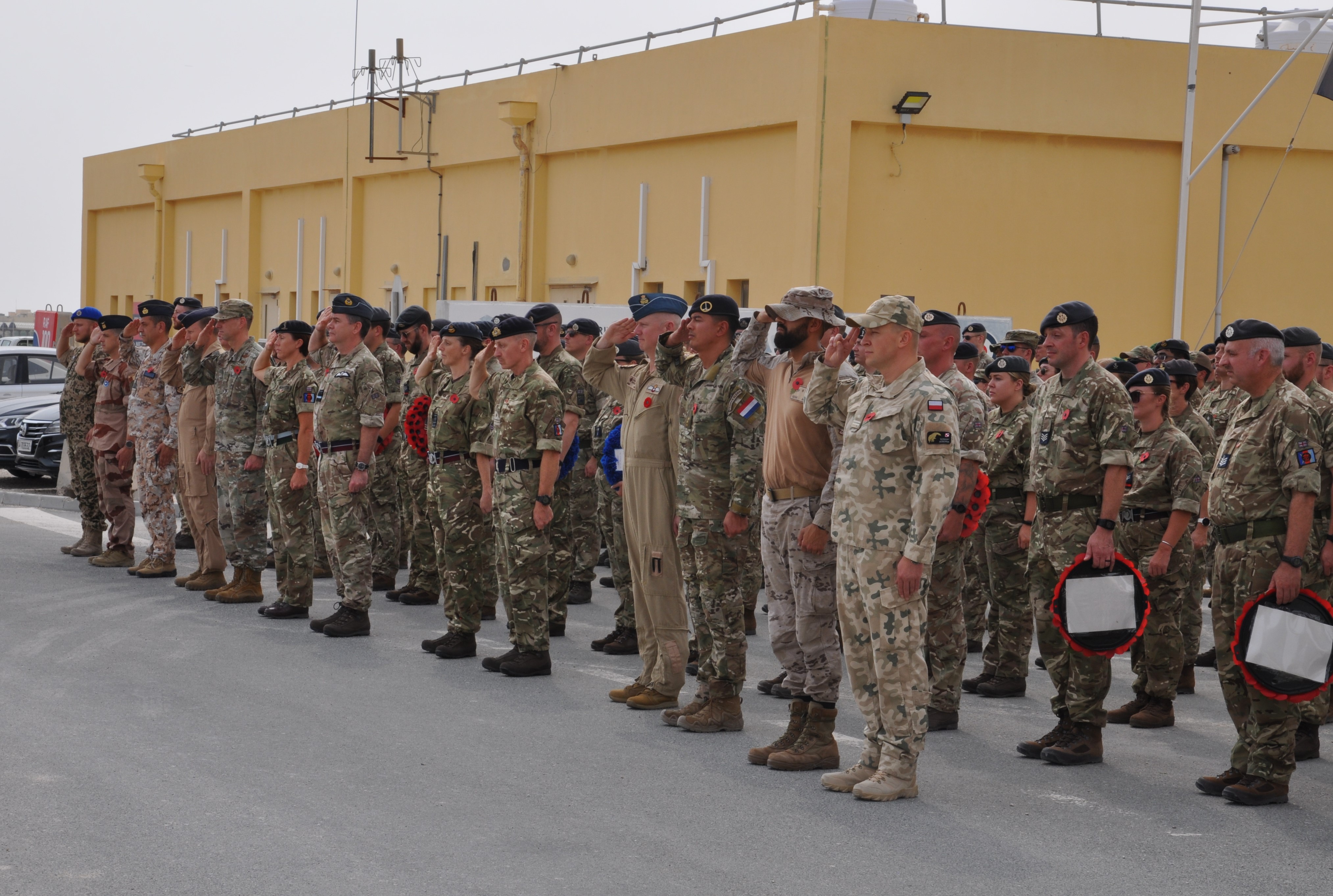Personnel in teh Middle East standing on parade and saluting during the service