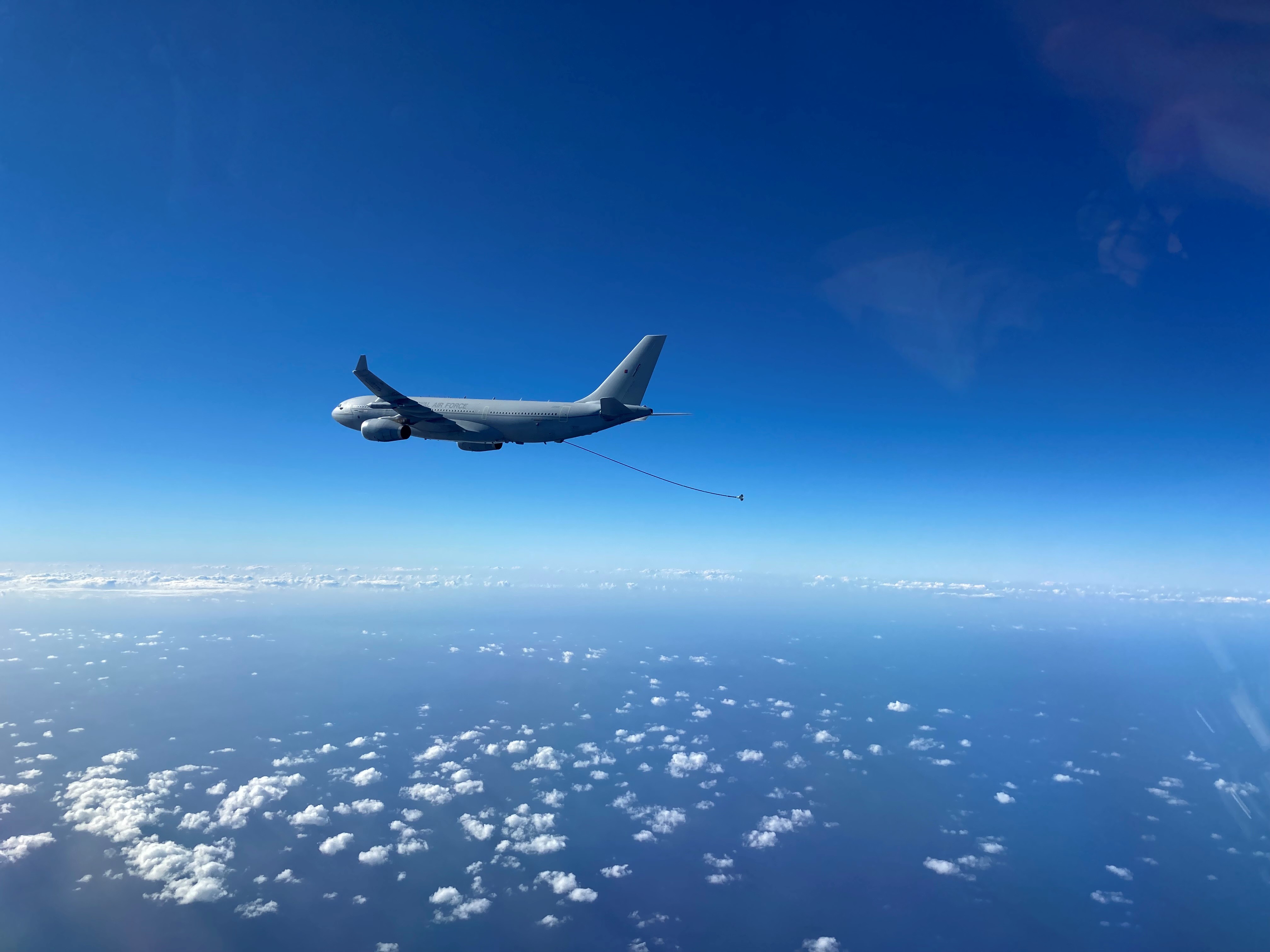 RAF Voyager aircraft flying against a bright blue sky