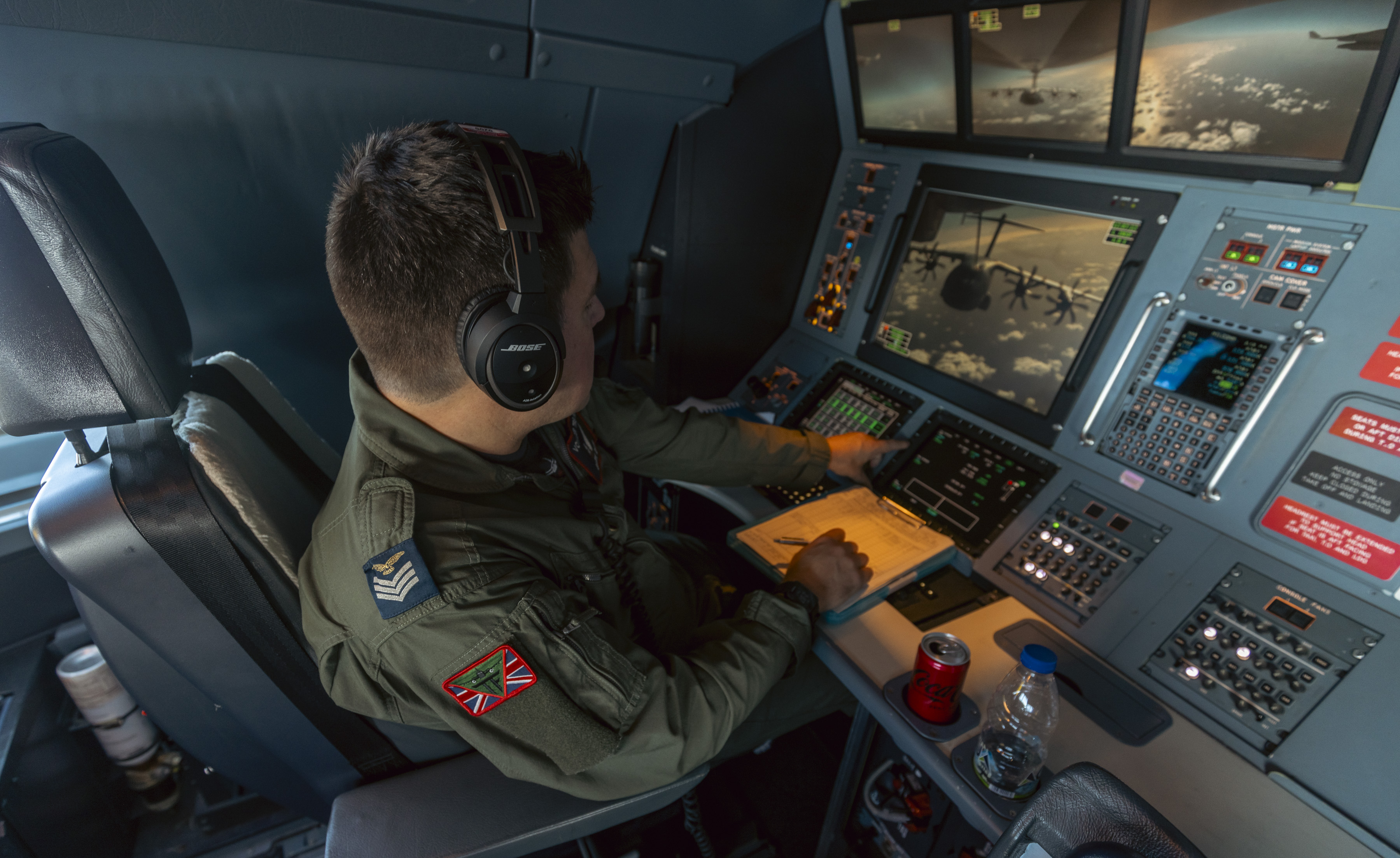 RAF personnel on board the Voyager dealing with the technology on board to assist the air-to-air refuelling