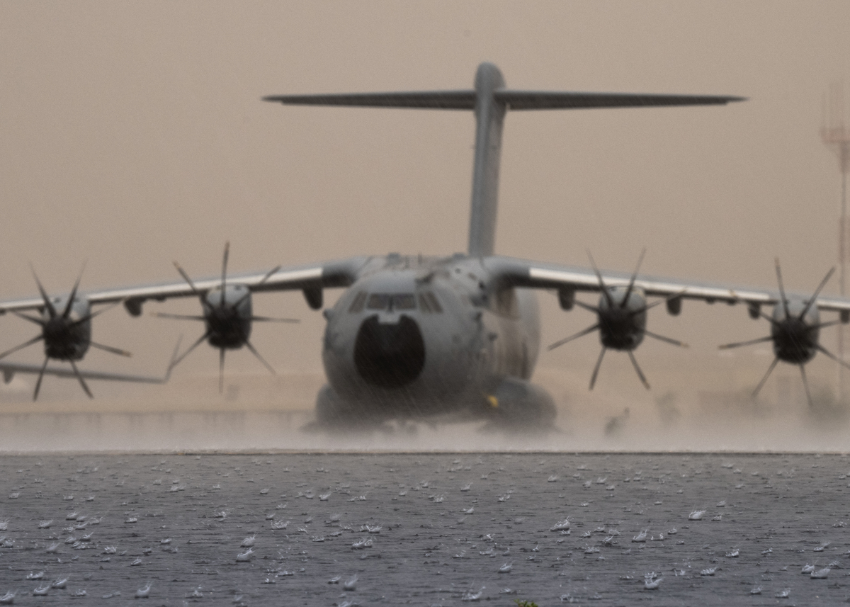 Atlas aircraft on runway in a heavy rainstorm