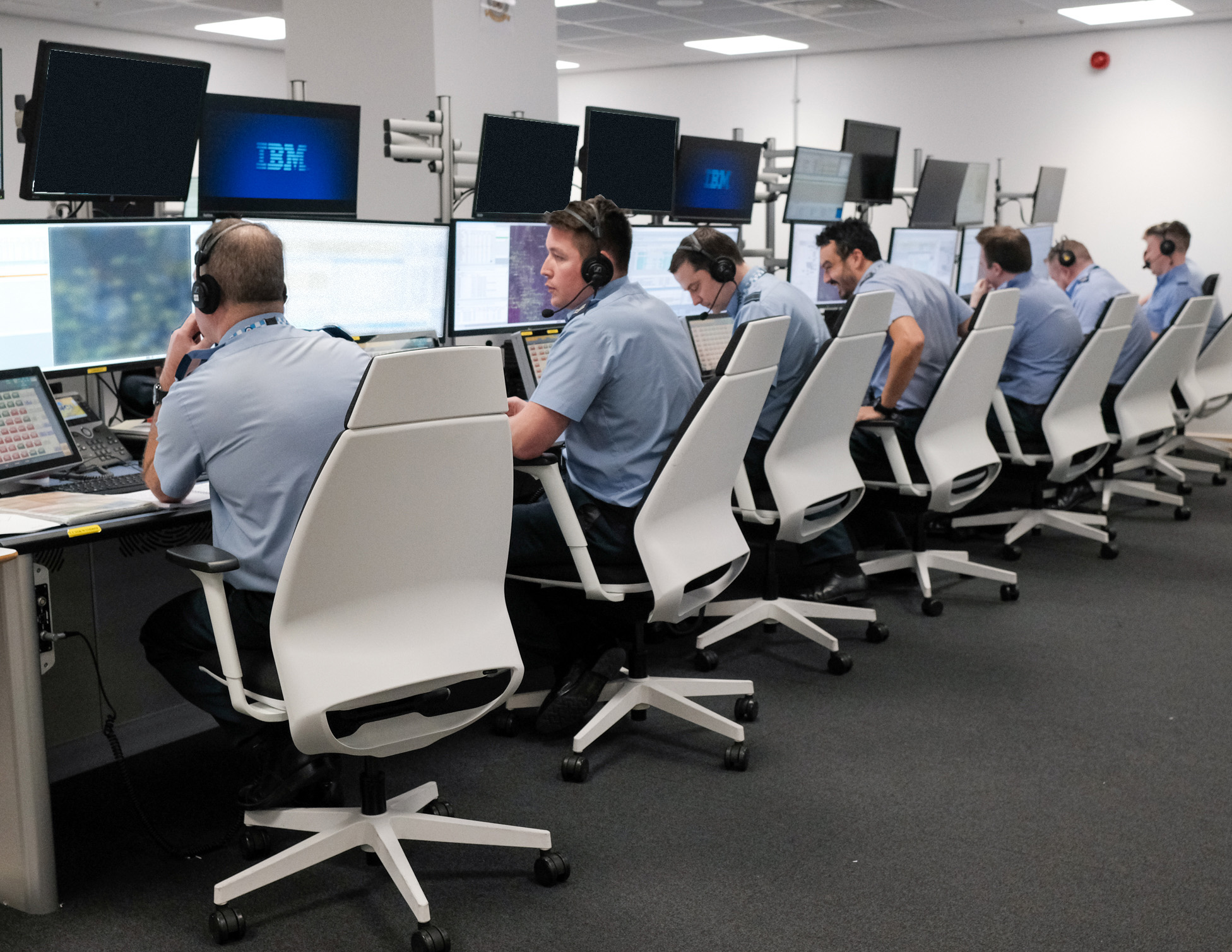 Battlespace Management Operators at work, sat at computers in a row wearing head sets