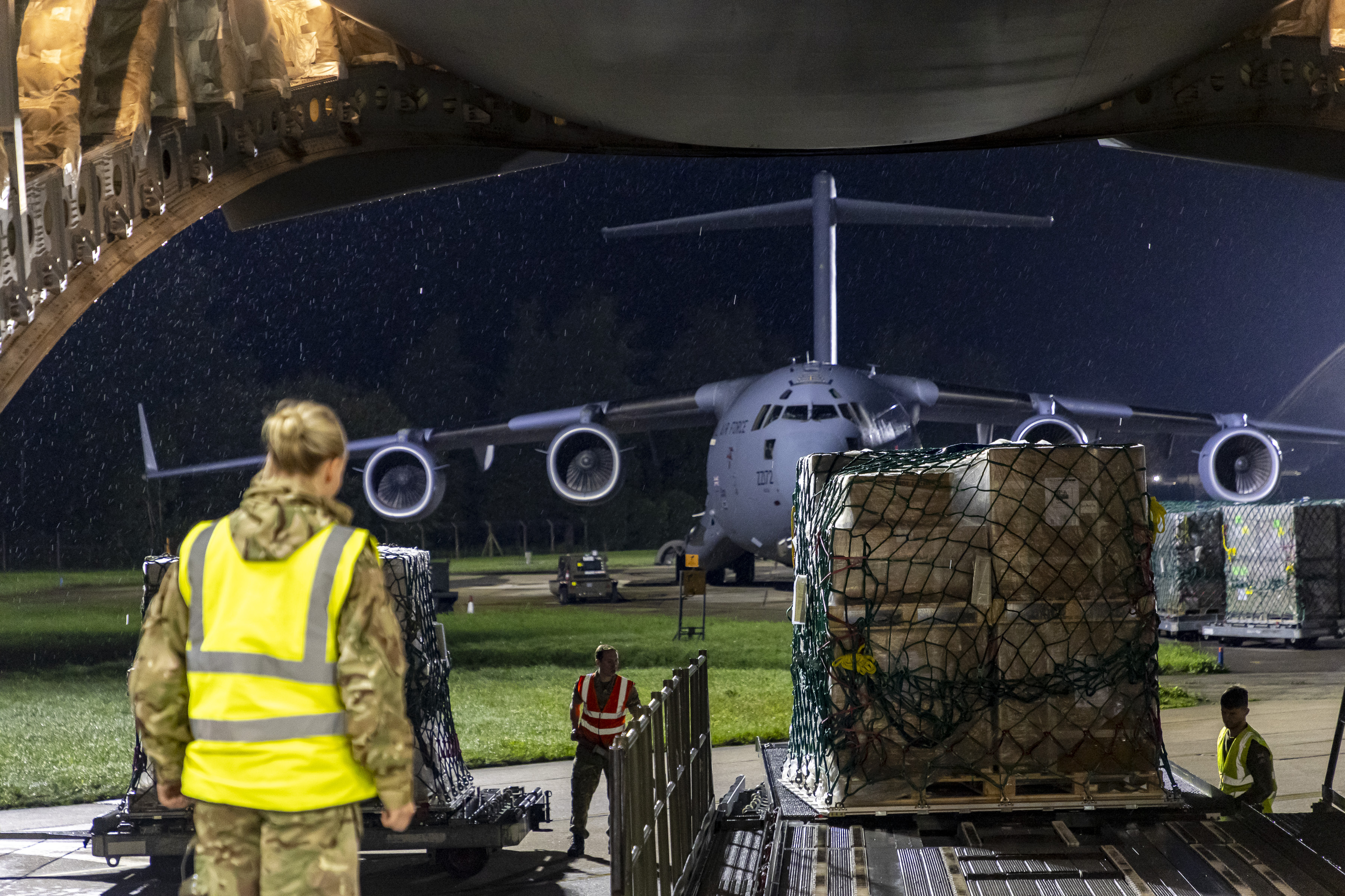 View from inside a C-17, watching as supplies are loaded on at night. 