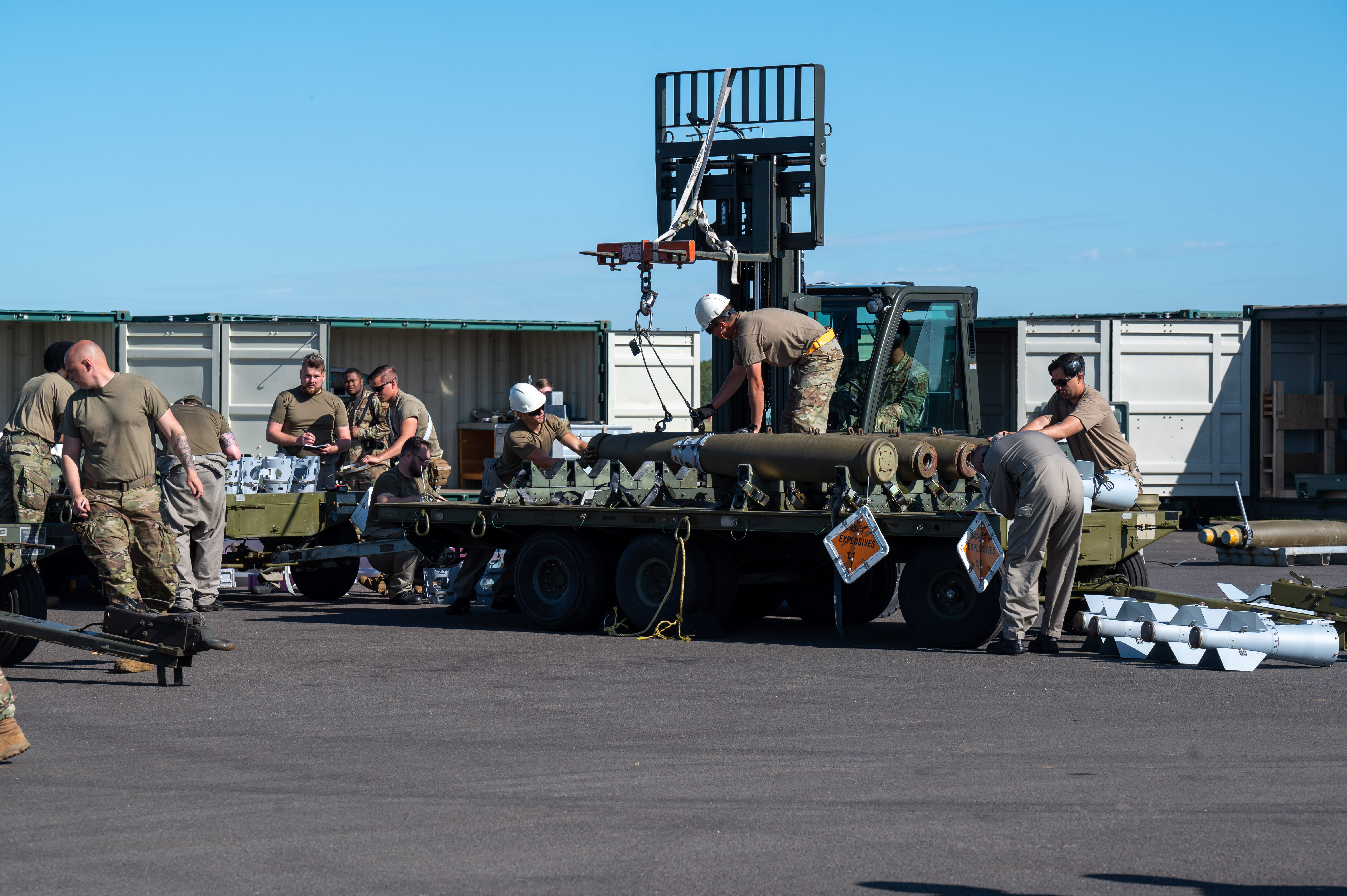 military personnel moving armaments