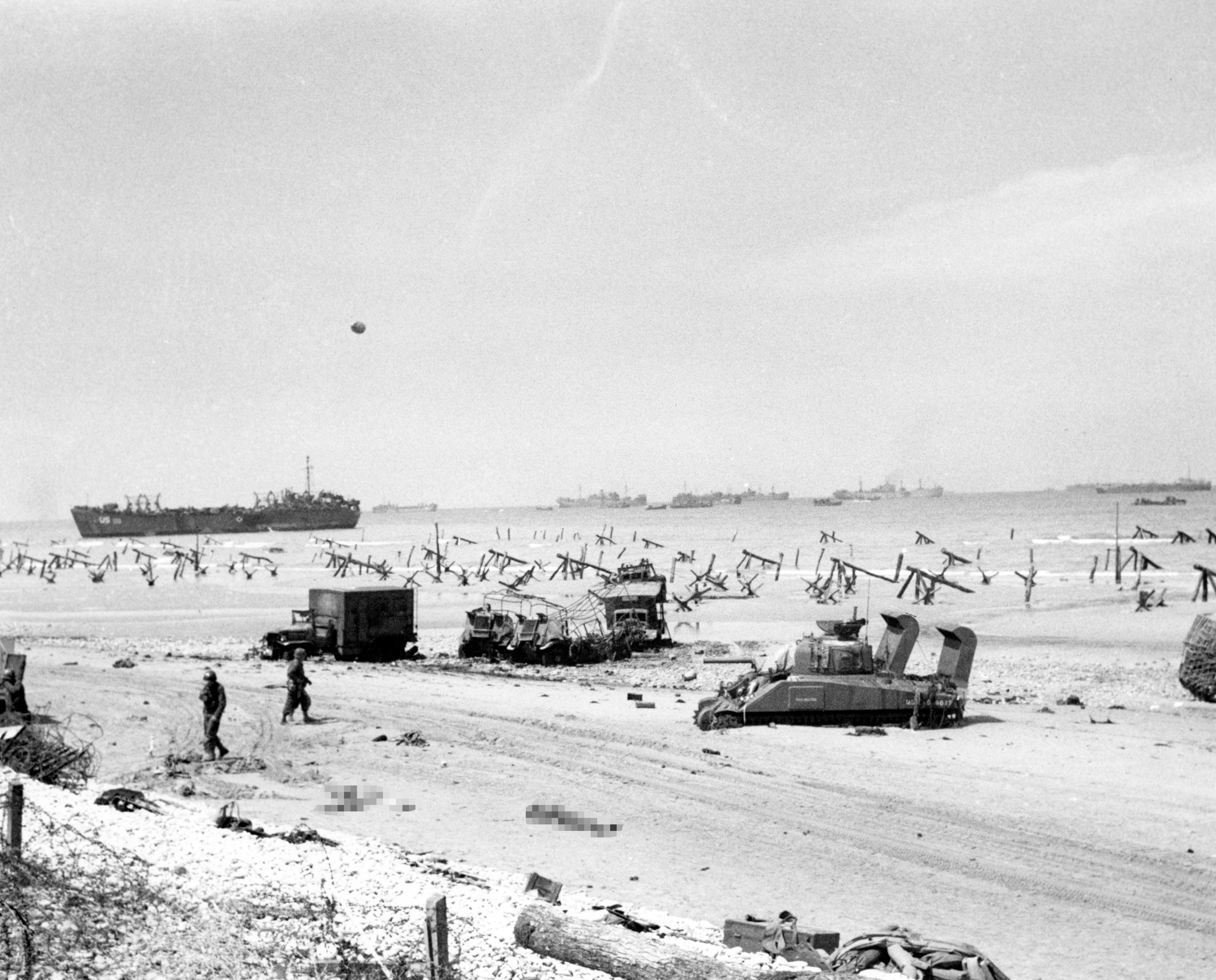 Image shows Omaha Beach on the afternoon of D-Day, with 21 BDS transmitter trucks and Landing Craft Tank