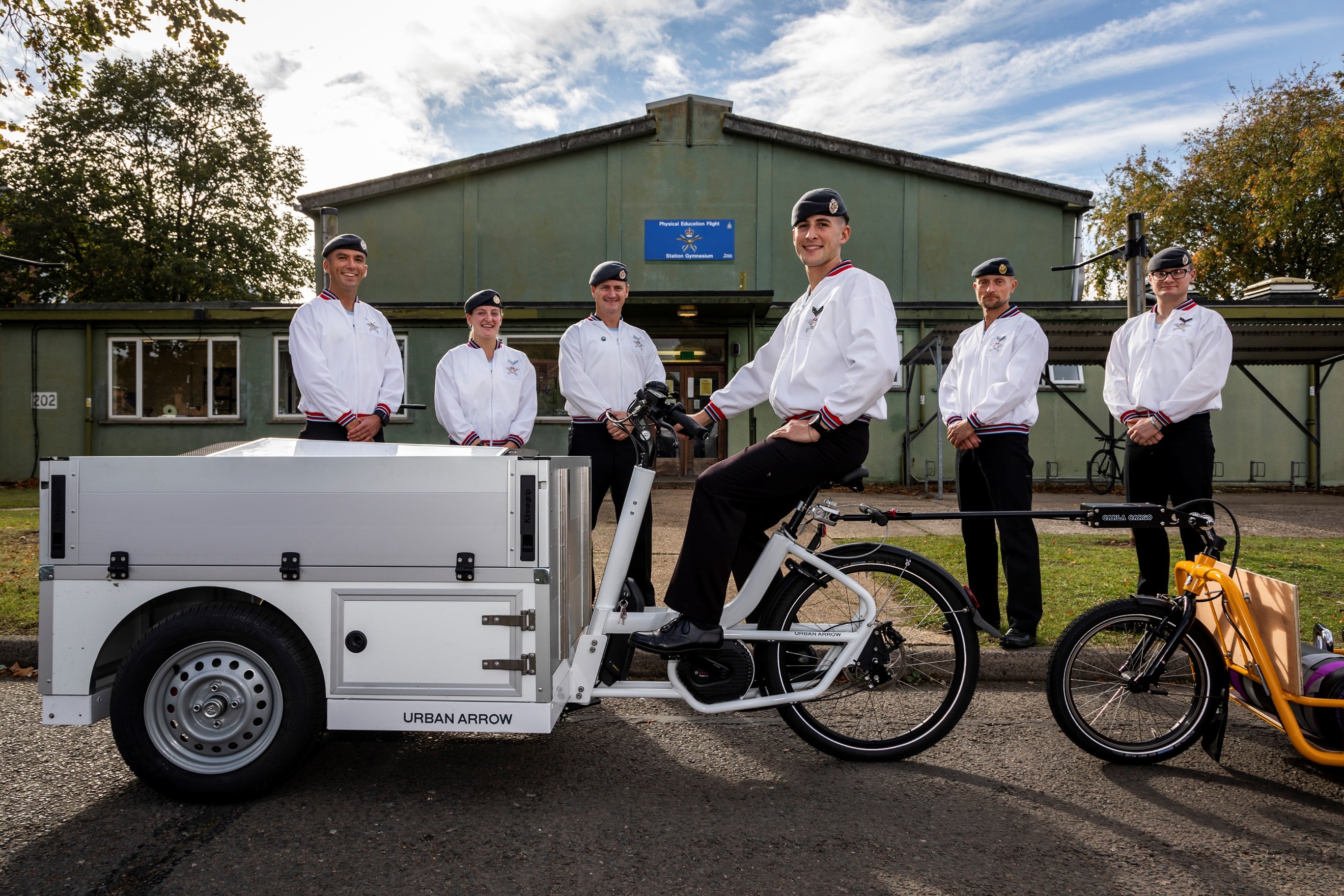RAF Physical Training Instructors pose with the electric bike