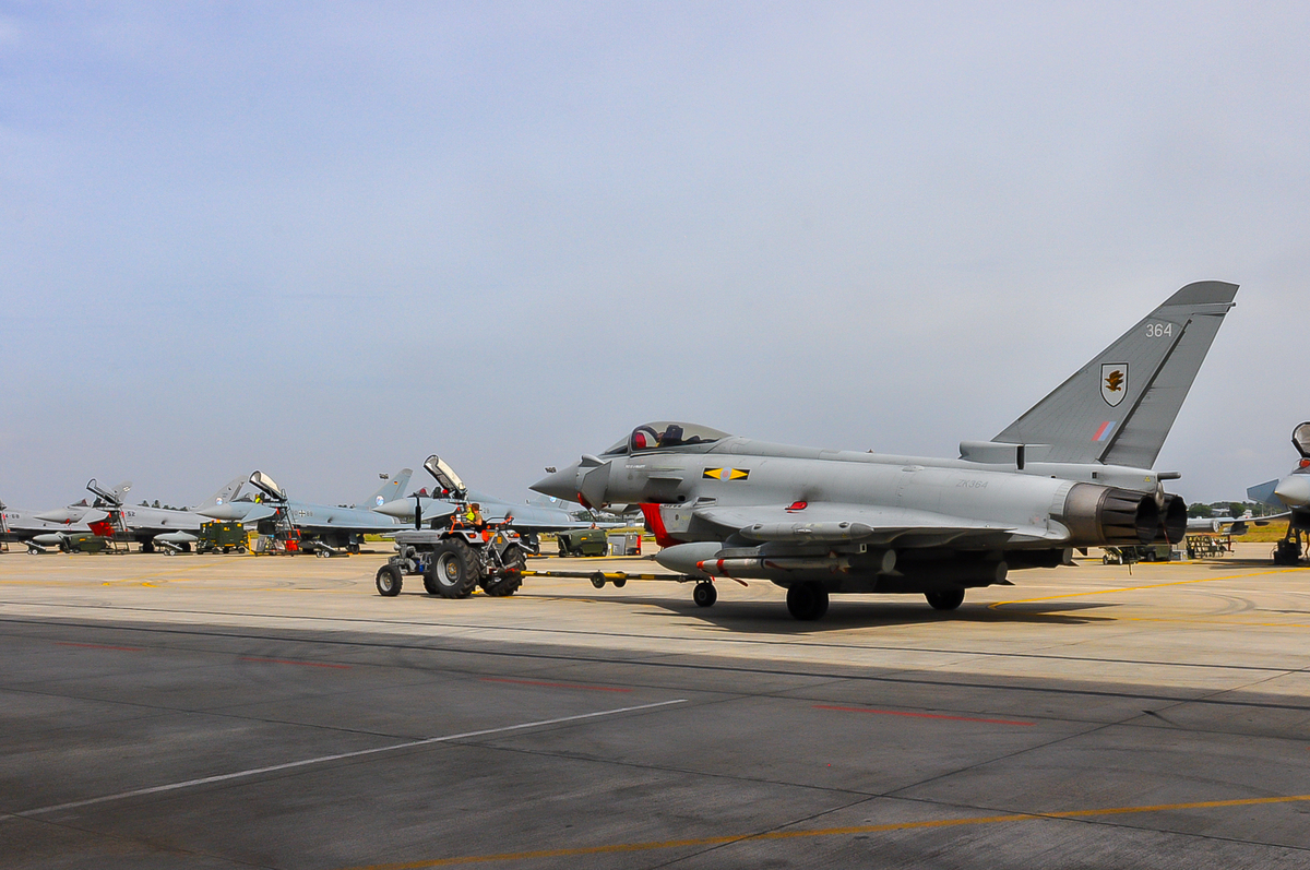 RAF Typhoon being towed with Eurofighters lined up in the background.