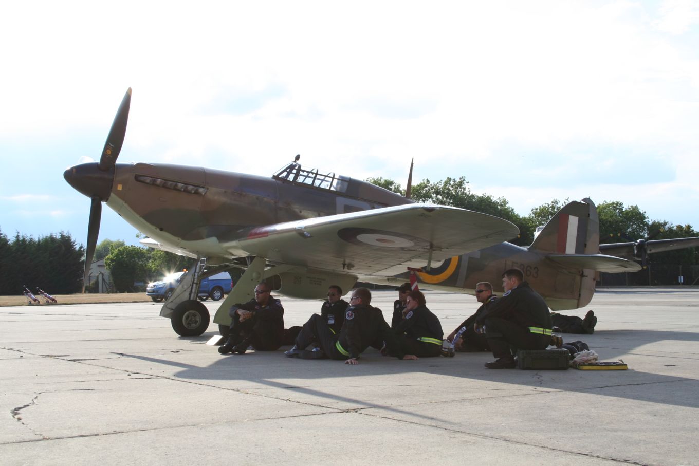 BBMF engineers sheltering from the sun in the shadow of a Hurricane