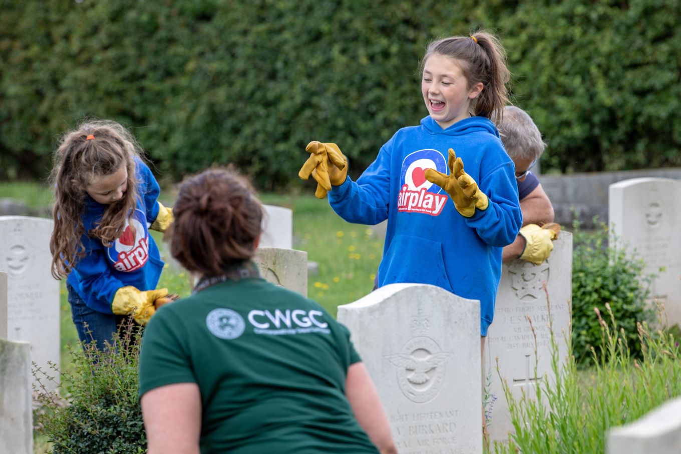 Sally McGlone and the young people cleaning war graves.