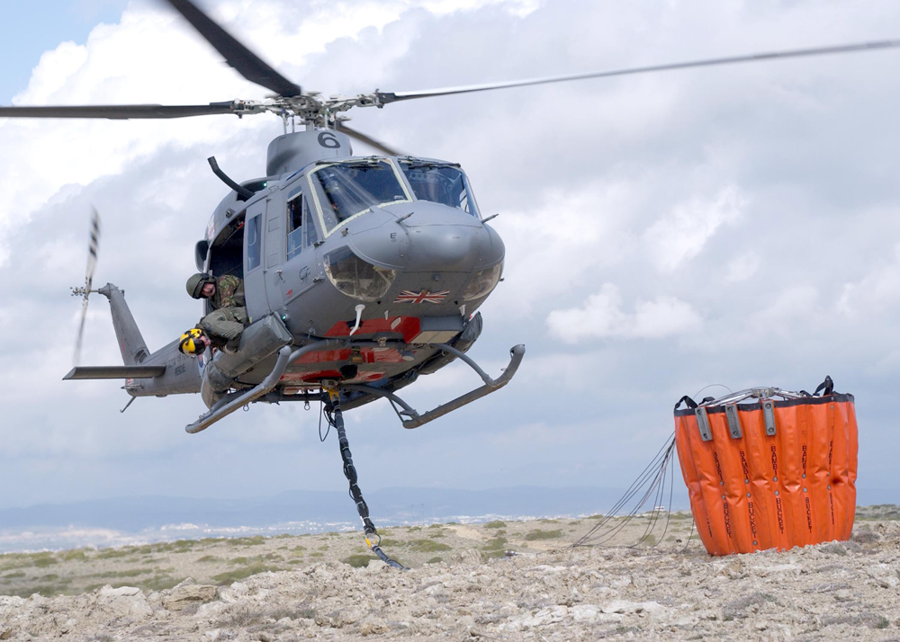 A Griffin HAR2 helicopter demonstrates the Bambi Bucket for fire fighting.