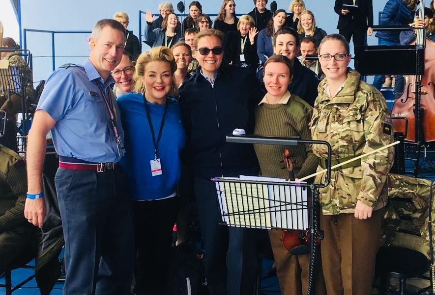Uniformed musicians pose for a picture with Sheridan Smith.