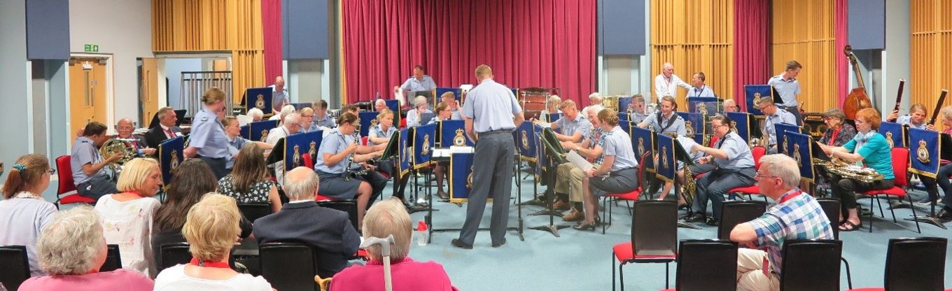 Uniformed and non-uniformed musicians of all ages play music together.
