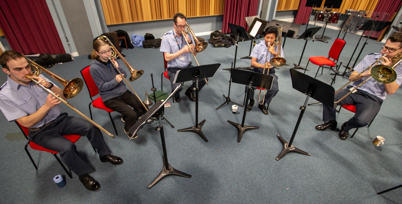A trombone quintet play music.