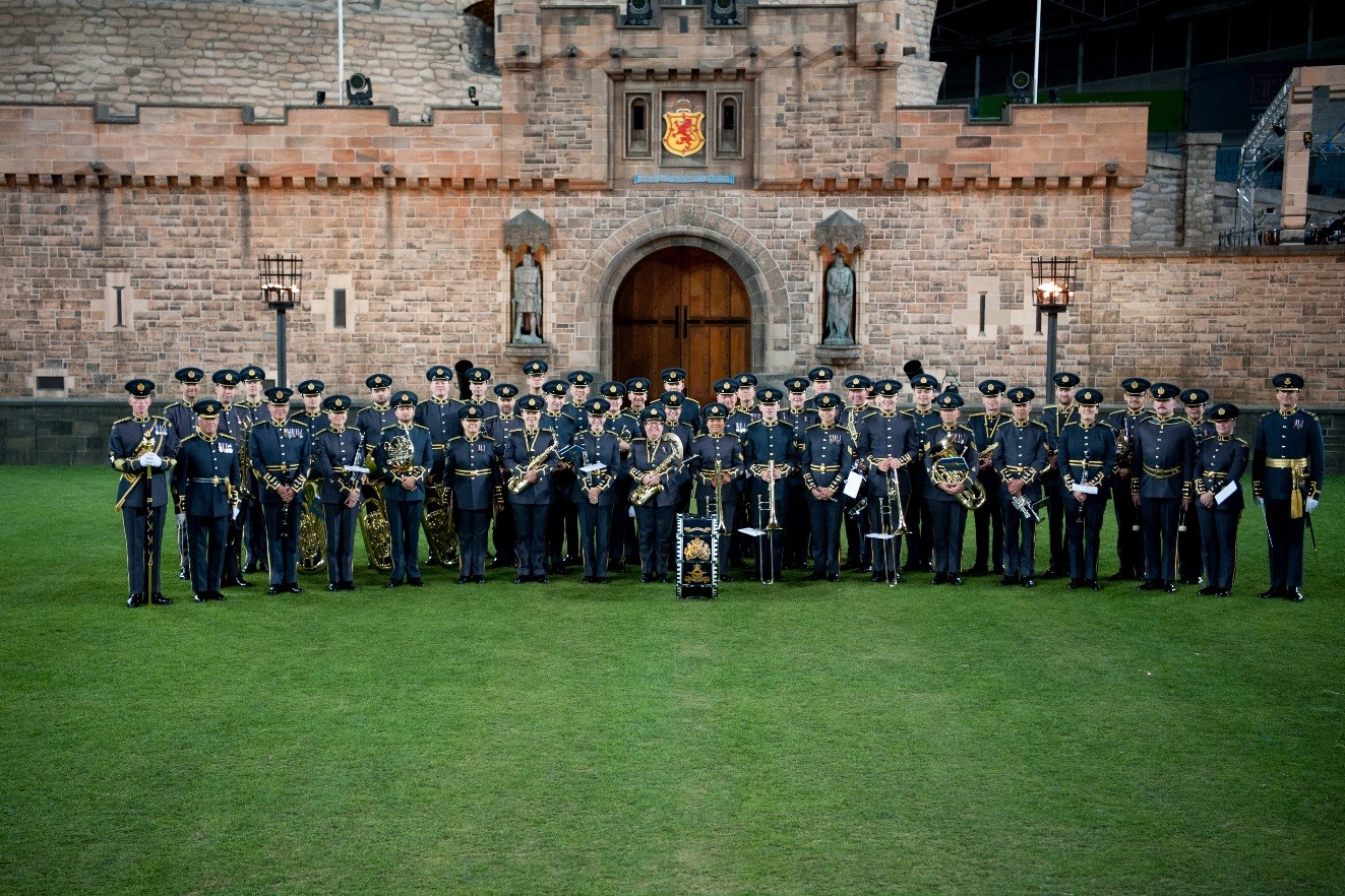 RAF Band are photographed in front of scenery made to look like Edinburgh Castle.