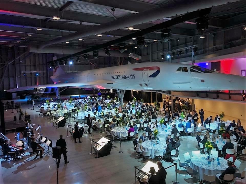 Large dinner gathering underneath Concorde