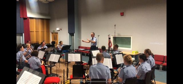 Royal Air Force musicians play music, pictured from behind the band..