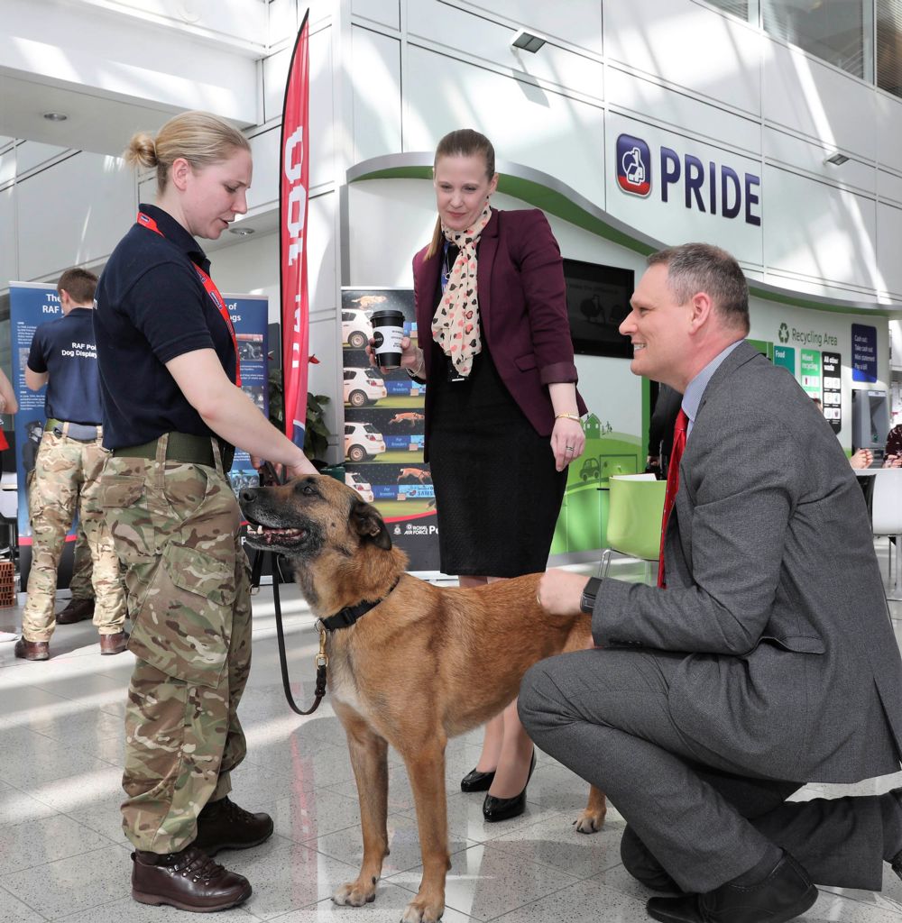 Employees of Nationwide speak to a member of the RAF Police Dog Display Team