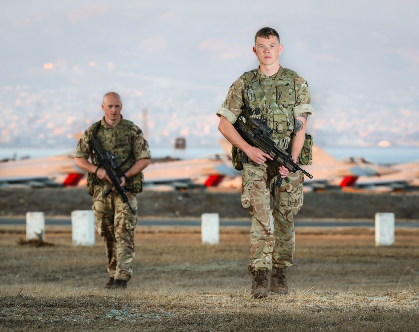 34 Sqn RAF Regiment routine patrol in front of Hercules C-130J aircraft RAF Akrotiri.