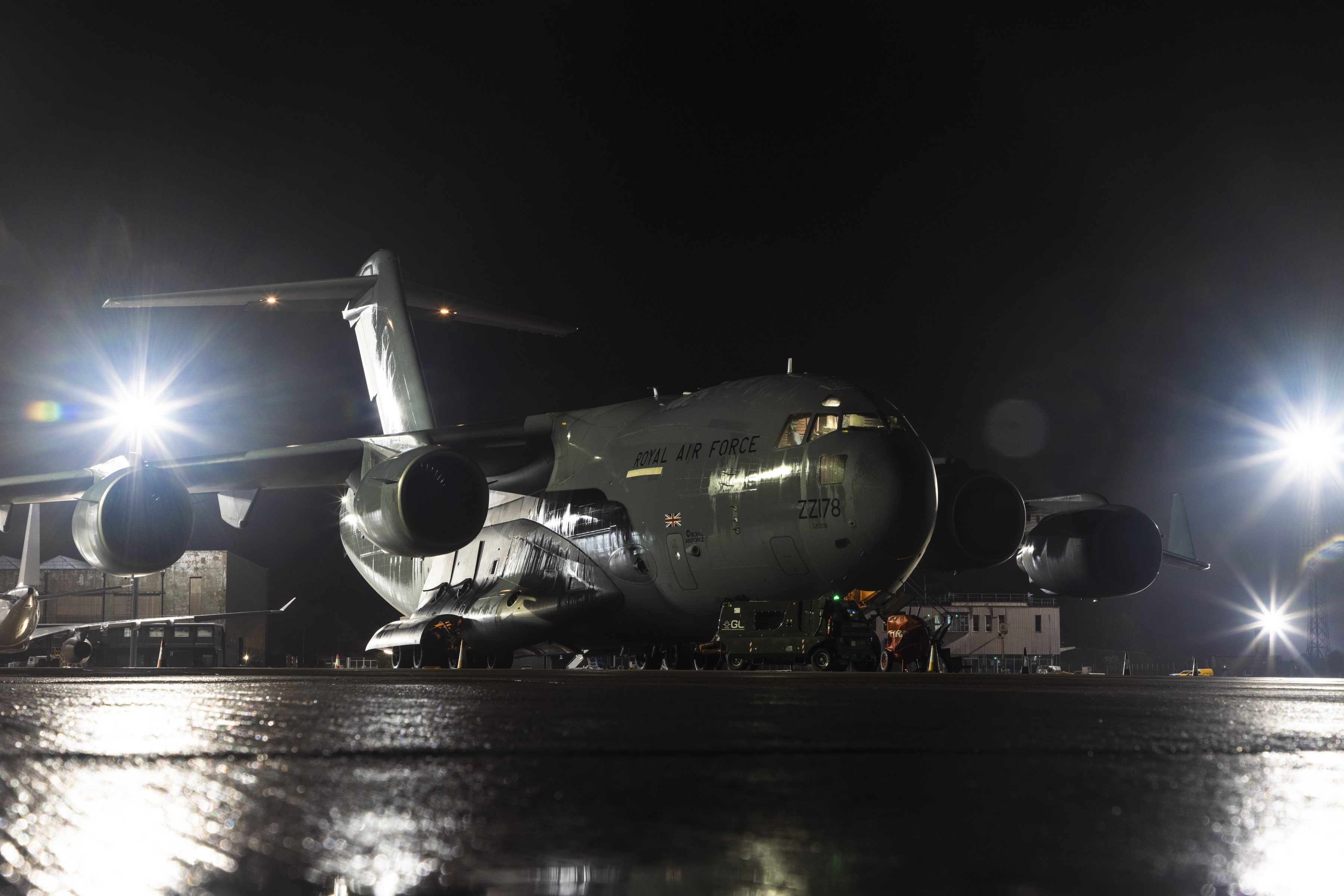 A400M ready to leave, on the runway at night.