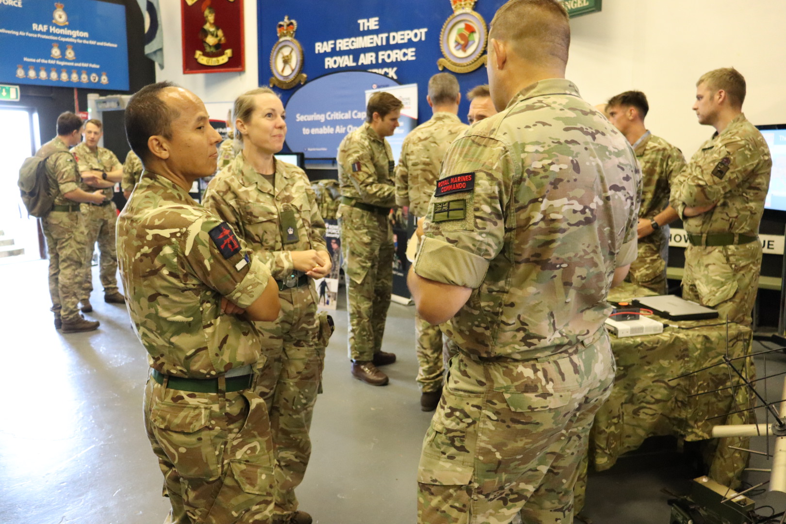 Military personnel from different services, chatting at the conference