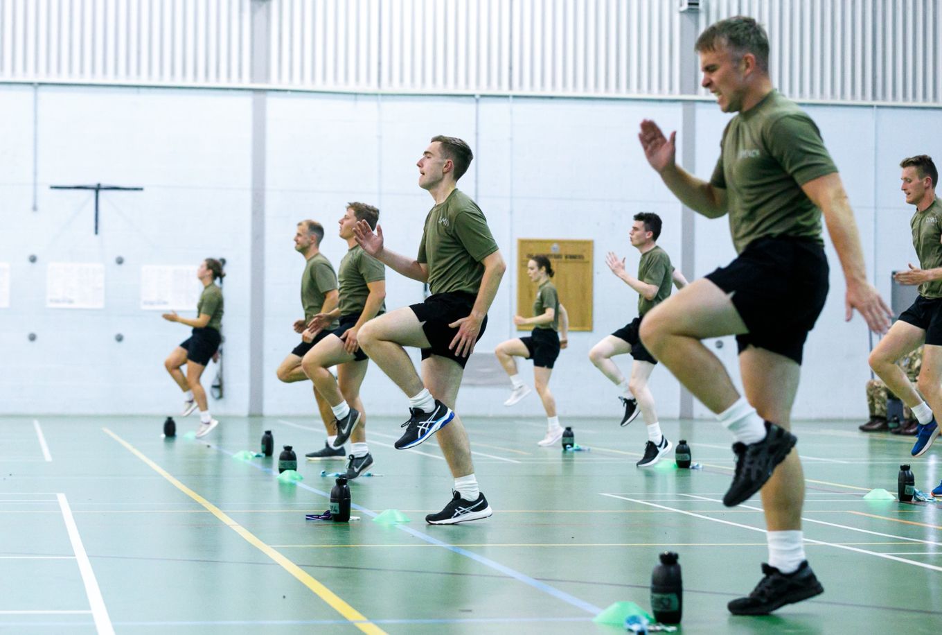 Personnel doing exercise in a gymnasium. 
