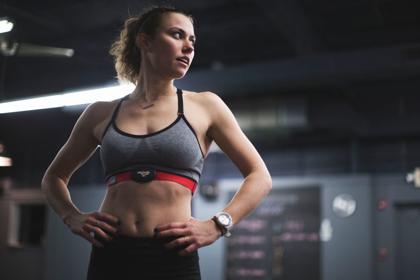 Image shows a women in gym gear using the Myzone fitness belt.