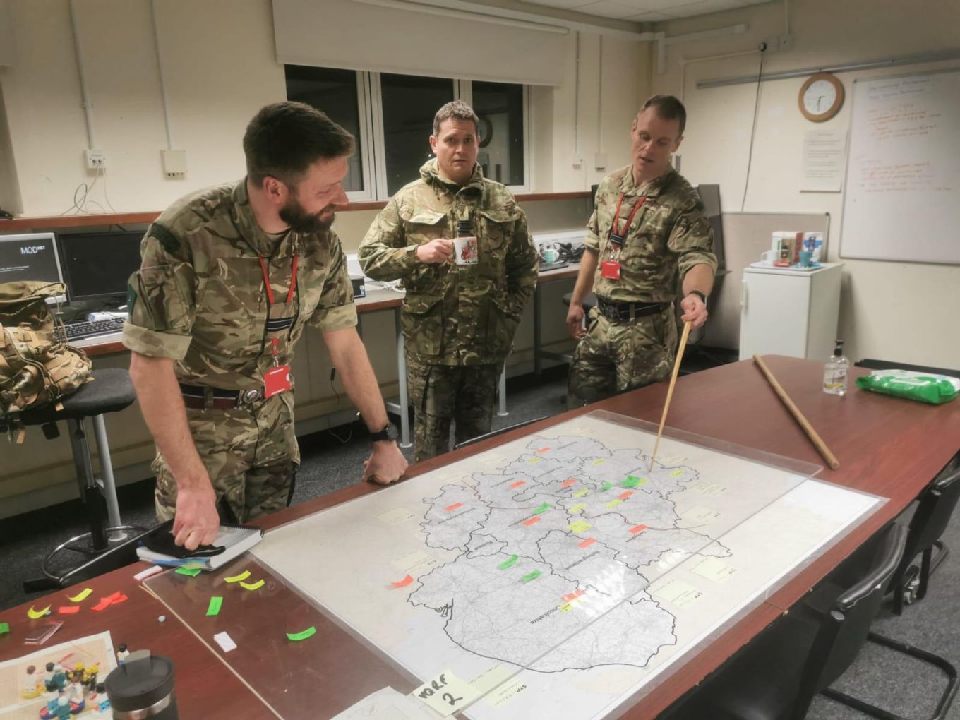Image shows Flight Lieutenants Clarke and Coatsworth working over a map on a table.
