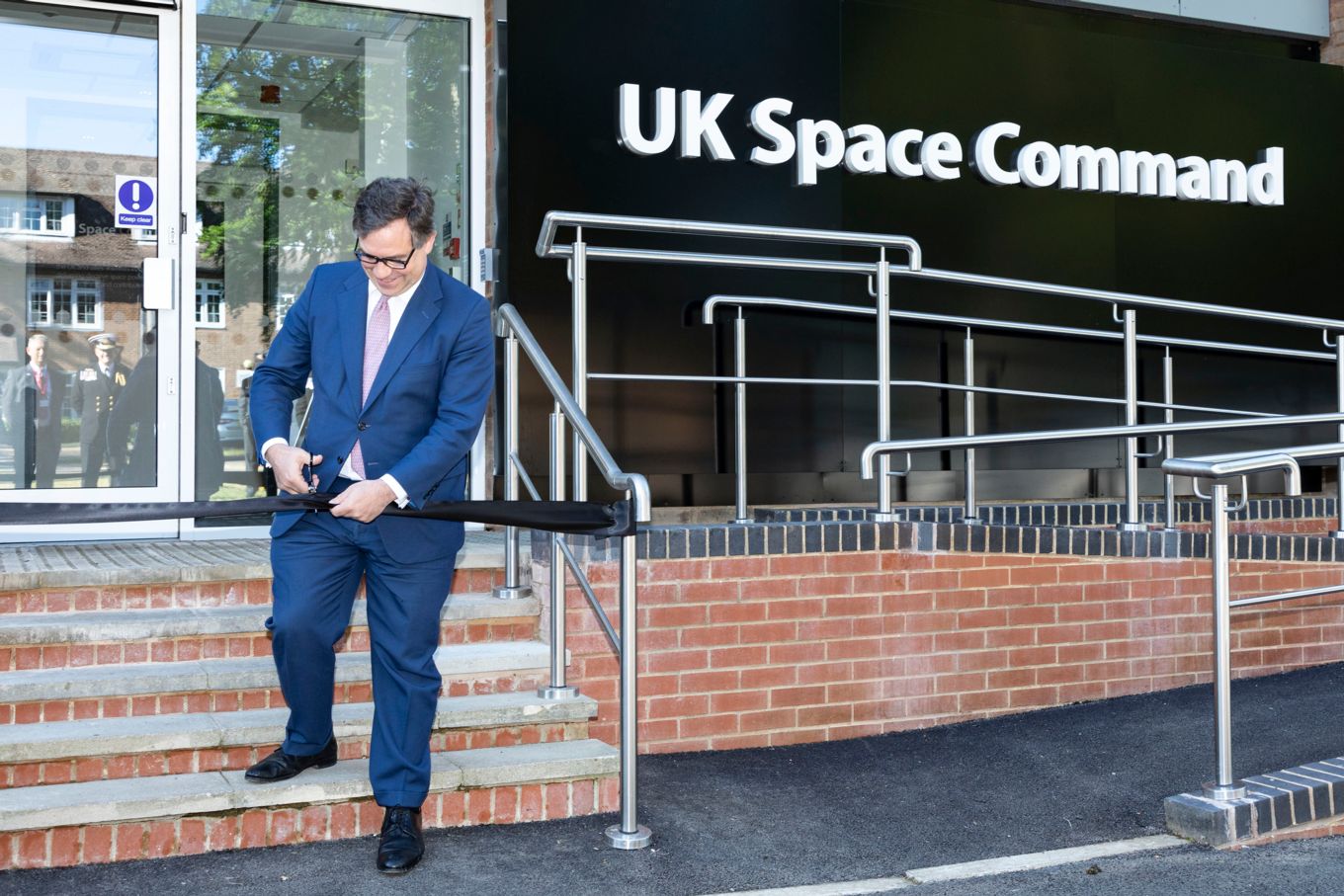 Cutting the tape outside the UK Space Command building. 