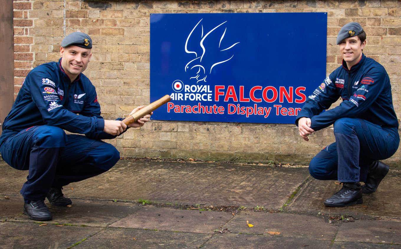Flight Lieutenant Ash Grey-Smart hands over the RAF Falcons baton to Flight Lieutenant Chris Wilce