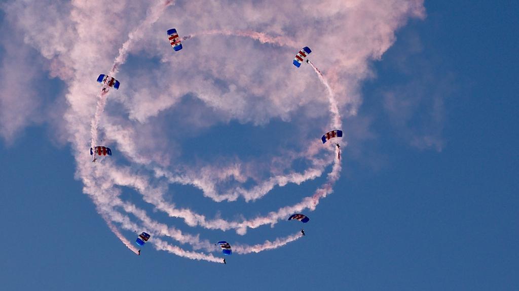The RAF Falcons decorating the skies above Carterton with their red and white smoke.